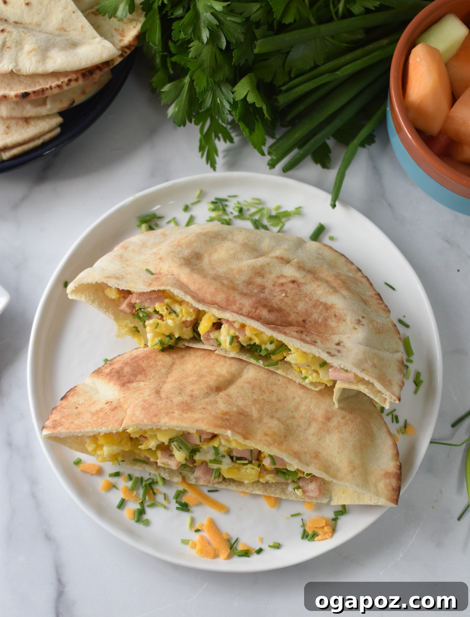 Savory Morning Pitas 4 A beautifully assembled Breakfast Pita garnished with fresh chives, ready to be enjoyed.