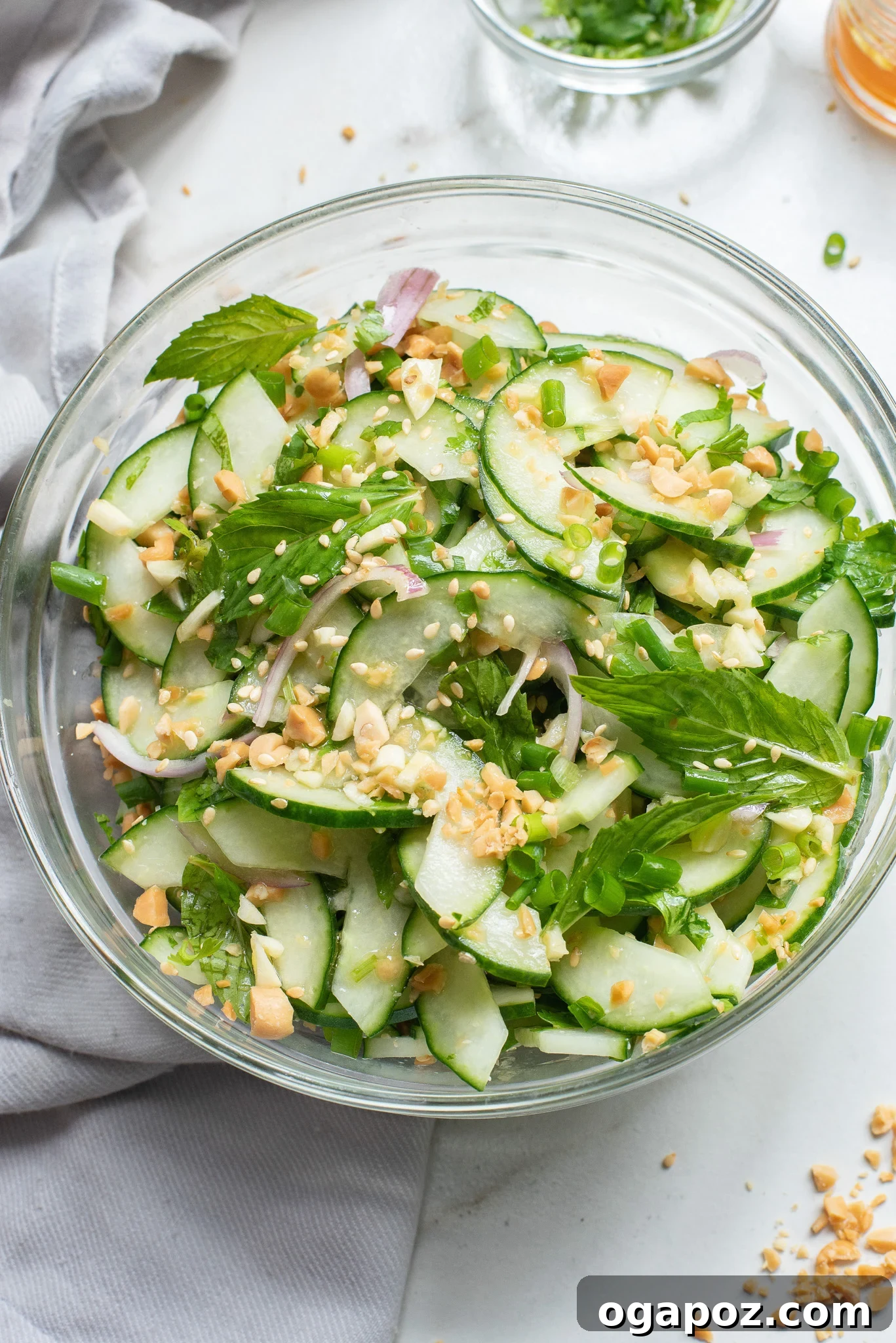 Zesty Thai Cucumber Delight 2 Beautifully presented Thai Cucumber Salad in a clear glass bowl, showcasing its fresh ingredients.
