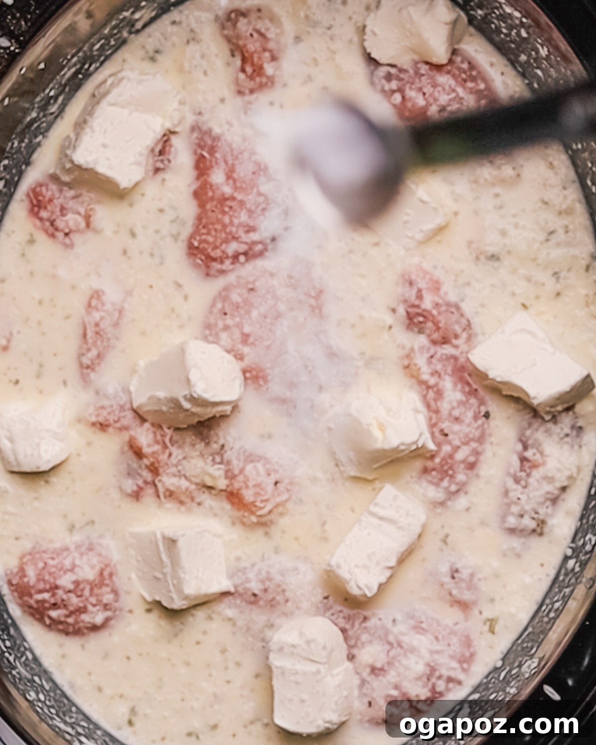 Creamy Slow Cooker Chicken Alfredo 5 Step 2: Placing seasoned chicken in the slow cooker for Crockpot Chicken Alfredo.