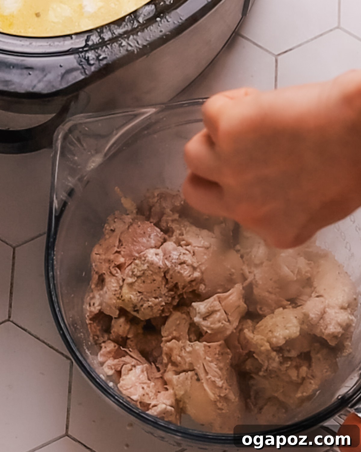 Creamy Slow Cooker Chicken Alfredo 6 Step 3: Adding cream cheese to the slow cooker for Crockpot Chicken Alfredo sauce.