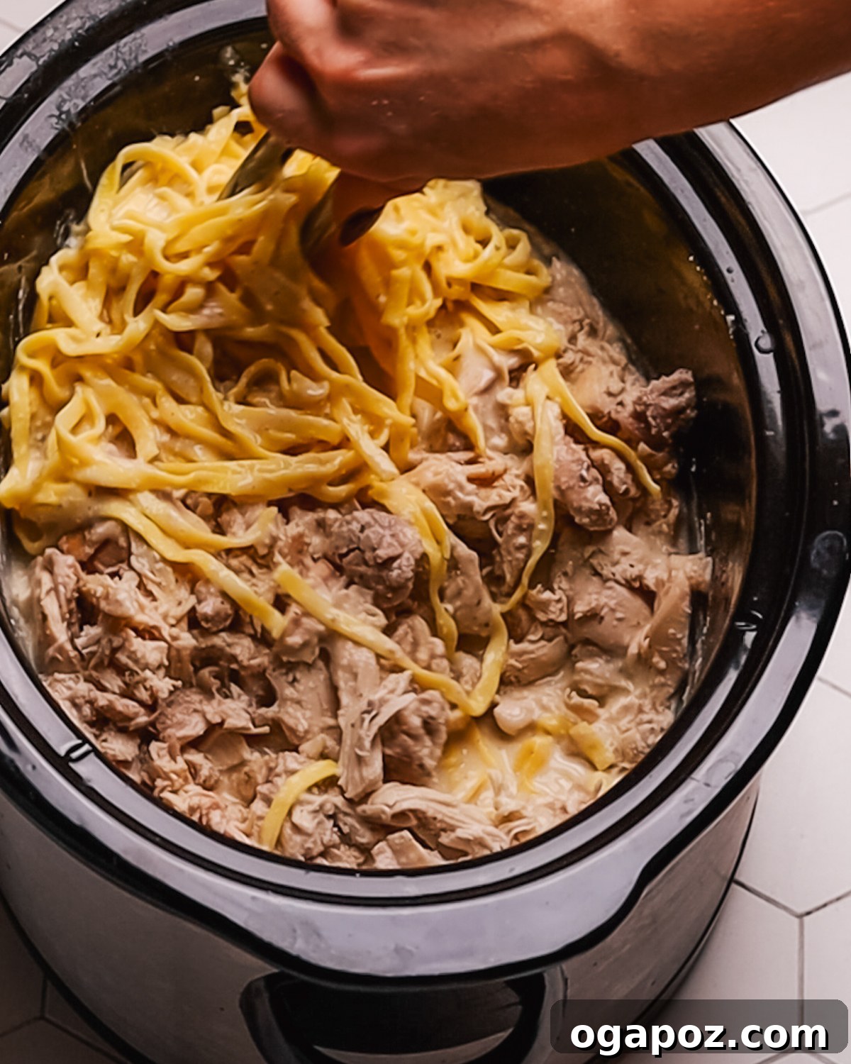 Creamy Slow Cooker Chicken Alfredo 8 Step 5: Shredding tender cooked chicken for Crockpot Chicken Alfredo.