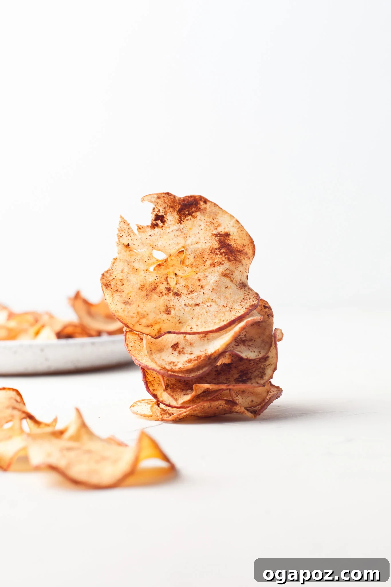 Simple Air Fryer Apple Crisps 5 Perfectly air-fried apple chips, stacked high and golden-brown, inviting a healthy and crispy snack experience.