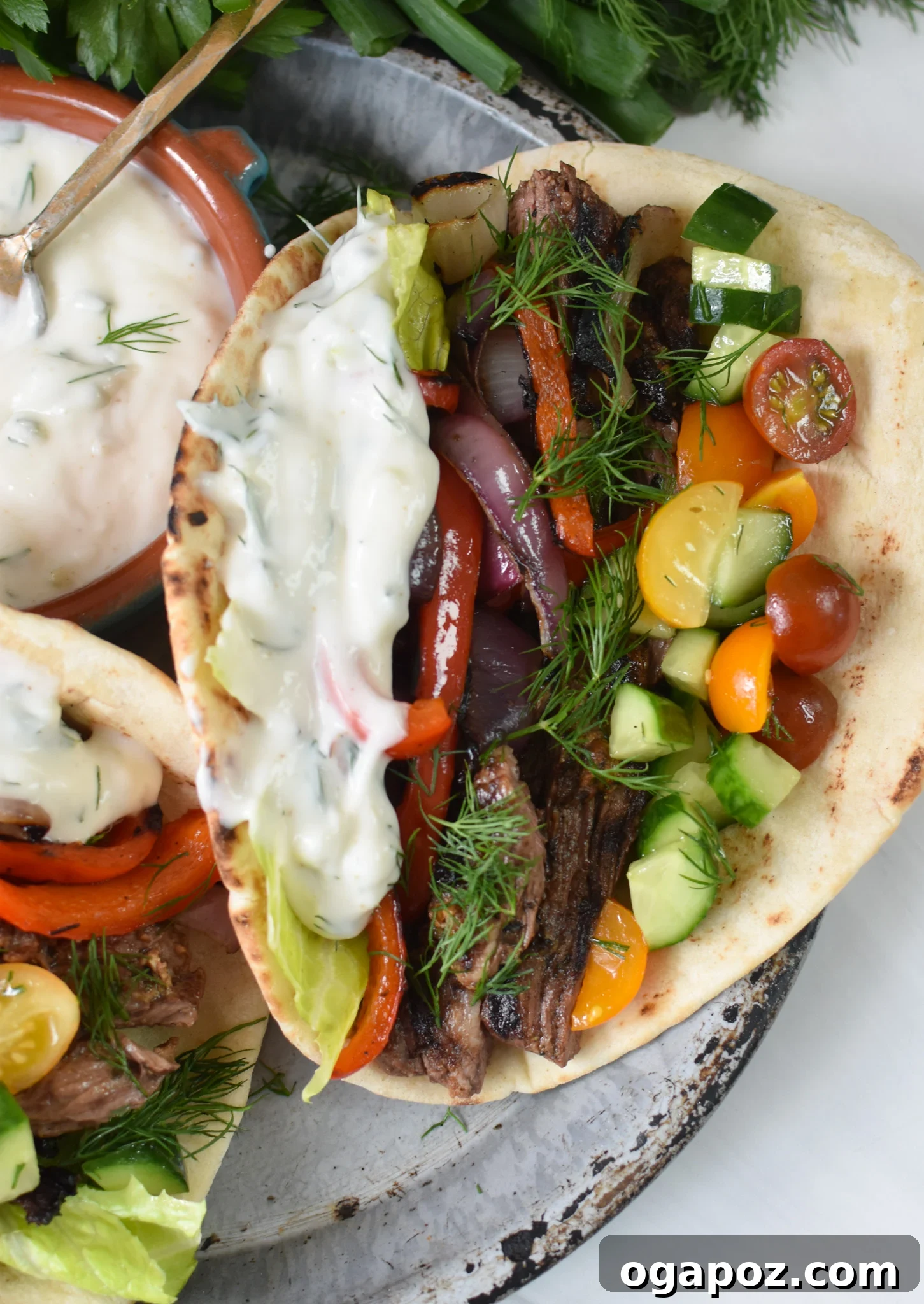 Quick Beef Gyro Wraps 2 Easy Beef Gyros served in warm pita bread with creamy tzatziki and fresh vegetables
