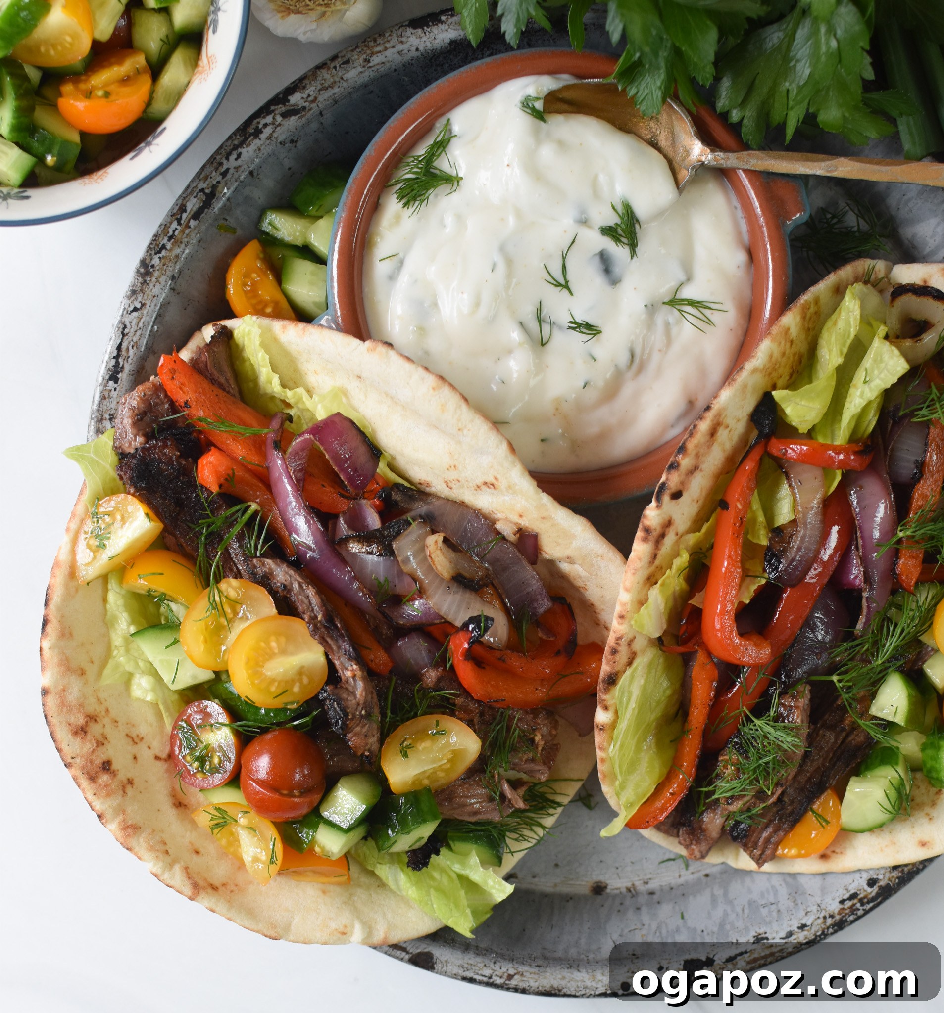 Quick Beef Gyro Wraps 12 Two fully assembled Easy Beef Gyros on a plate, garnished with fresh herbs