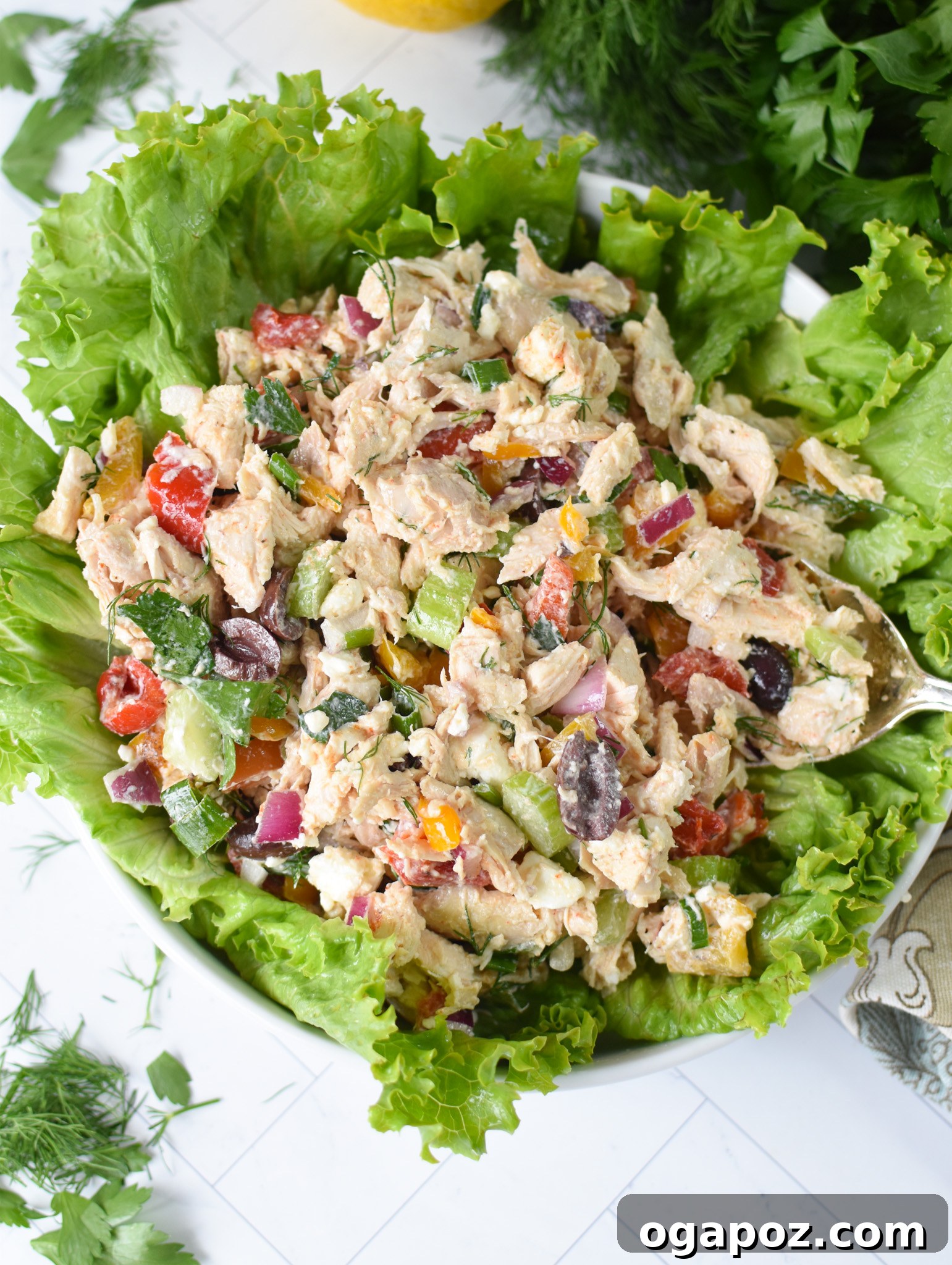 Vibrant Mediterranean Chicken Salad 3 Healthy Mediterranean Chicken Salad served over a vibrant bed of fresh lettuce.