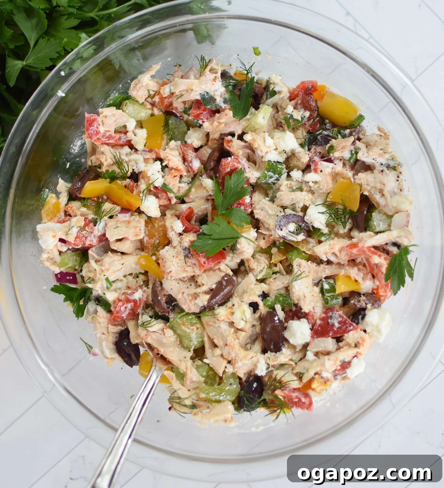 Vibrant Mediterranean Chicken Salad 10 Healthy Mediterranean Chicken Salad ingredients thoroughly mixed in a large bowl, ready for serving.