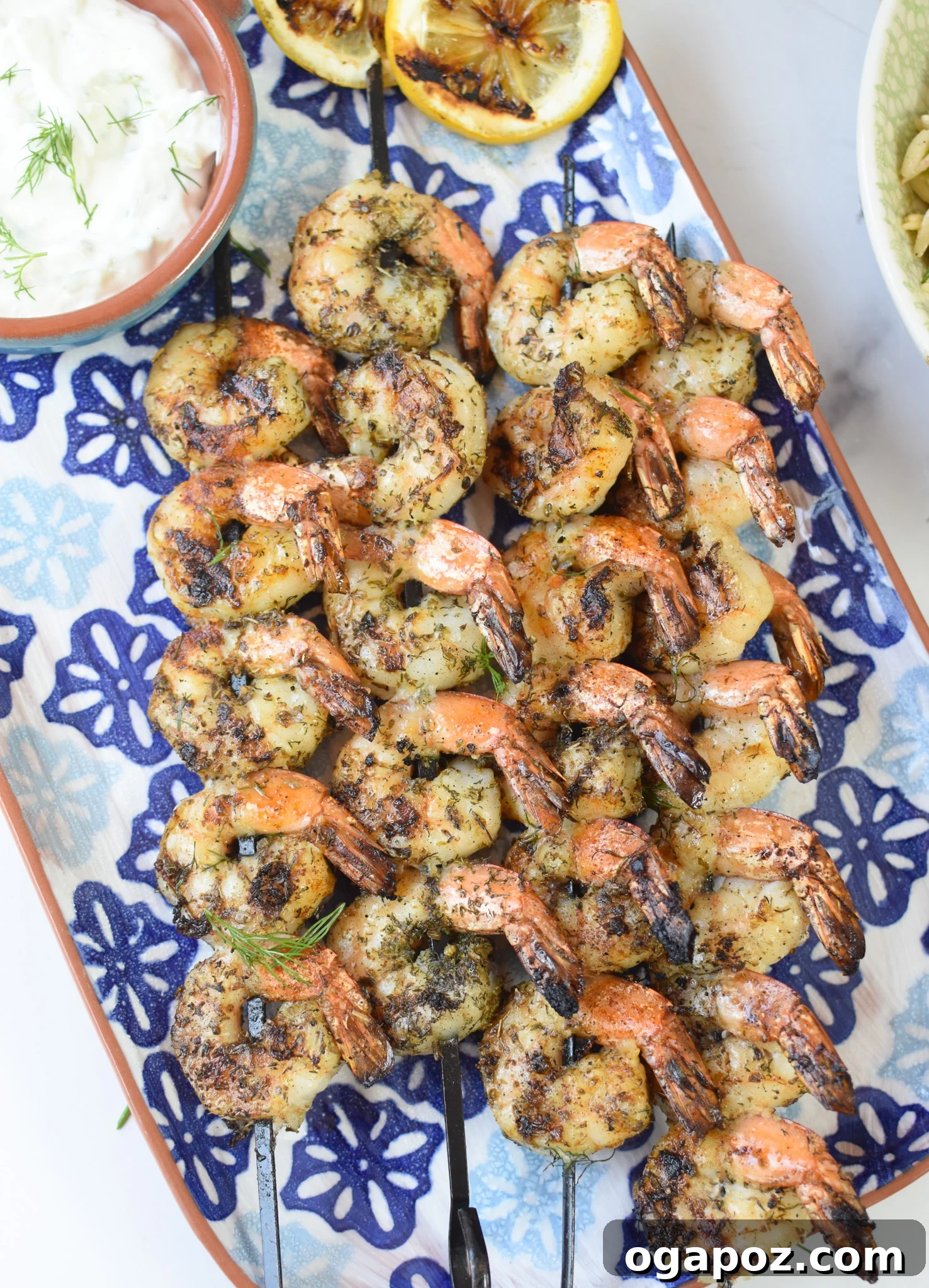 Zesty Greek Shrimp Marinade 7 Perfectly grilled Greek shrimp presented on a blue ceramic plate, ready to be enjoyed.
