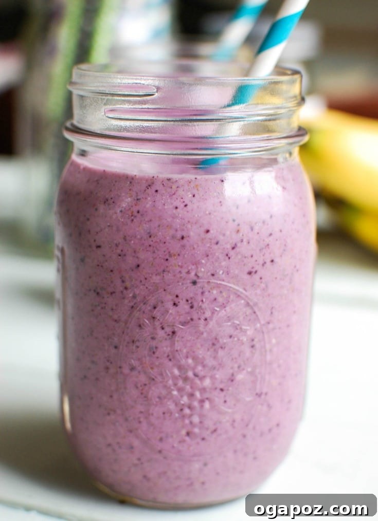 Velvet Blueberry Banana Smoothie 2 Vibrant Blueberry Banana Smoothie in a clear glass, ready to be enjoyed.