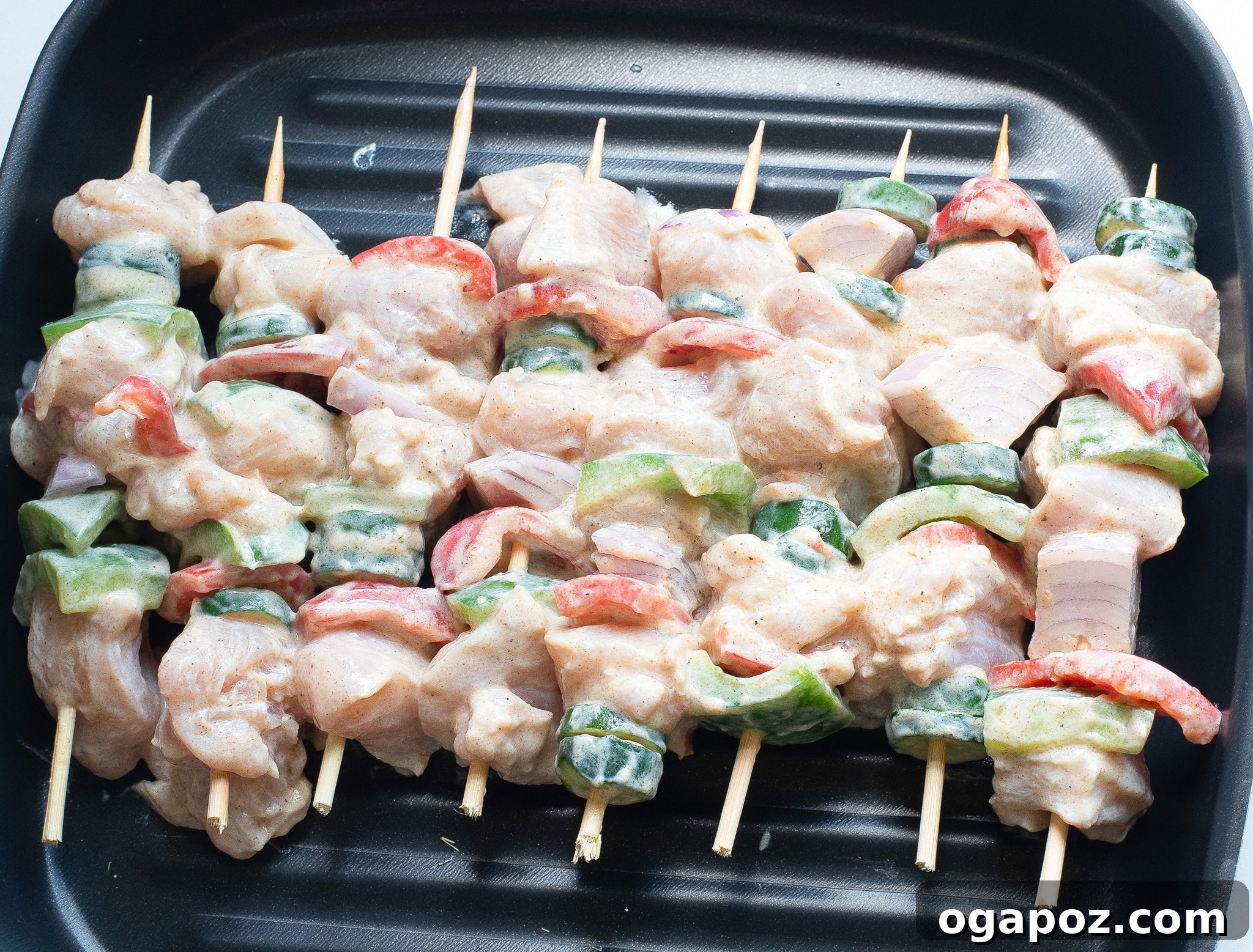 Zesty Greek Lemon Chicken Skewers 6 Greek Marinated Chicken Kabobs with Lemon cooking on a hot grill, showing the beautiful char and vibrant colors.