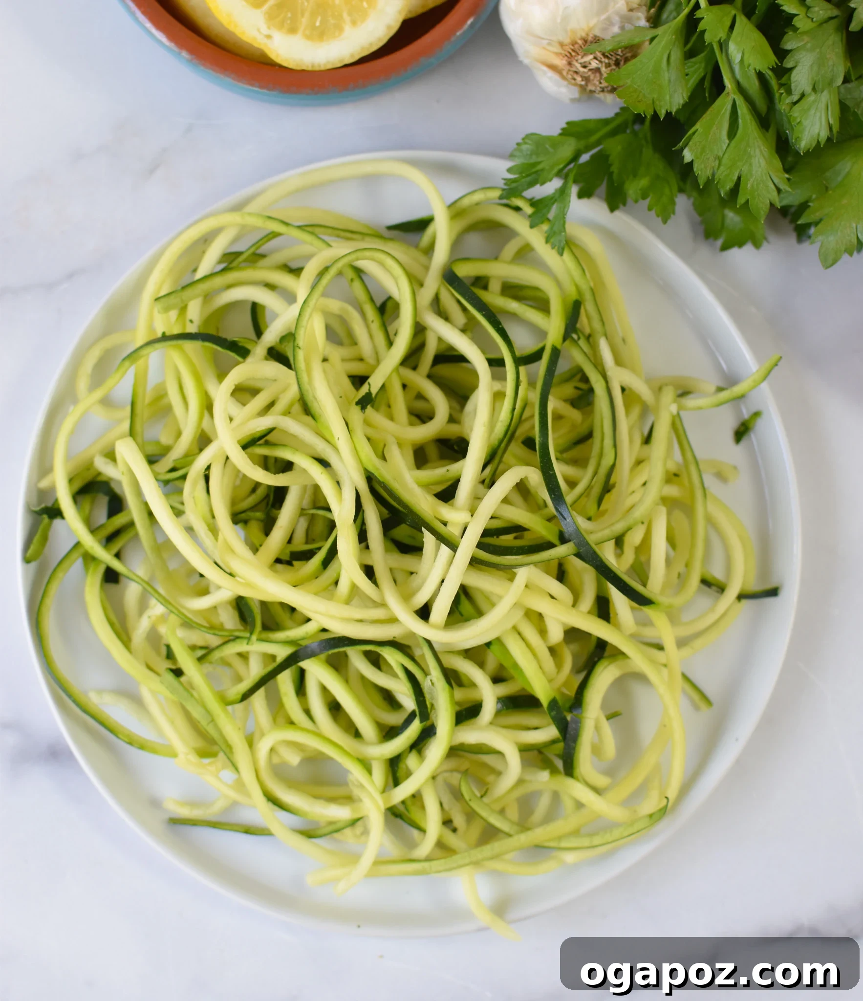 Creamy Zucchini Noodle Alfredo 5 Alfredo Zoodles Recipe zucchini noodles on a plate, drying.