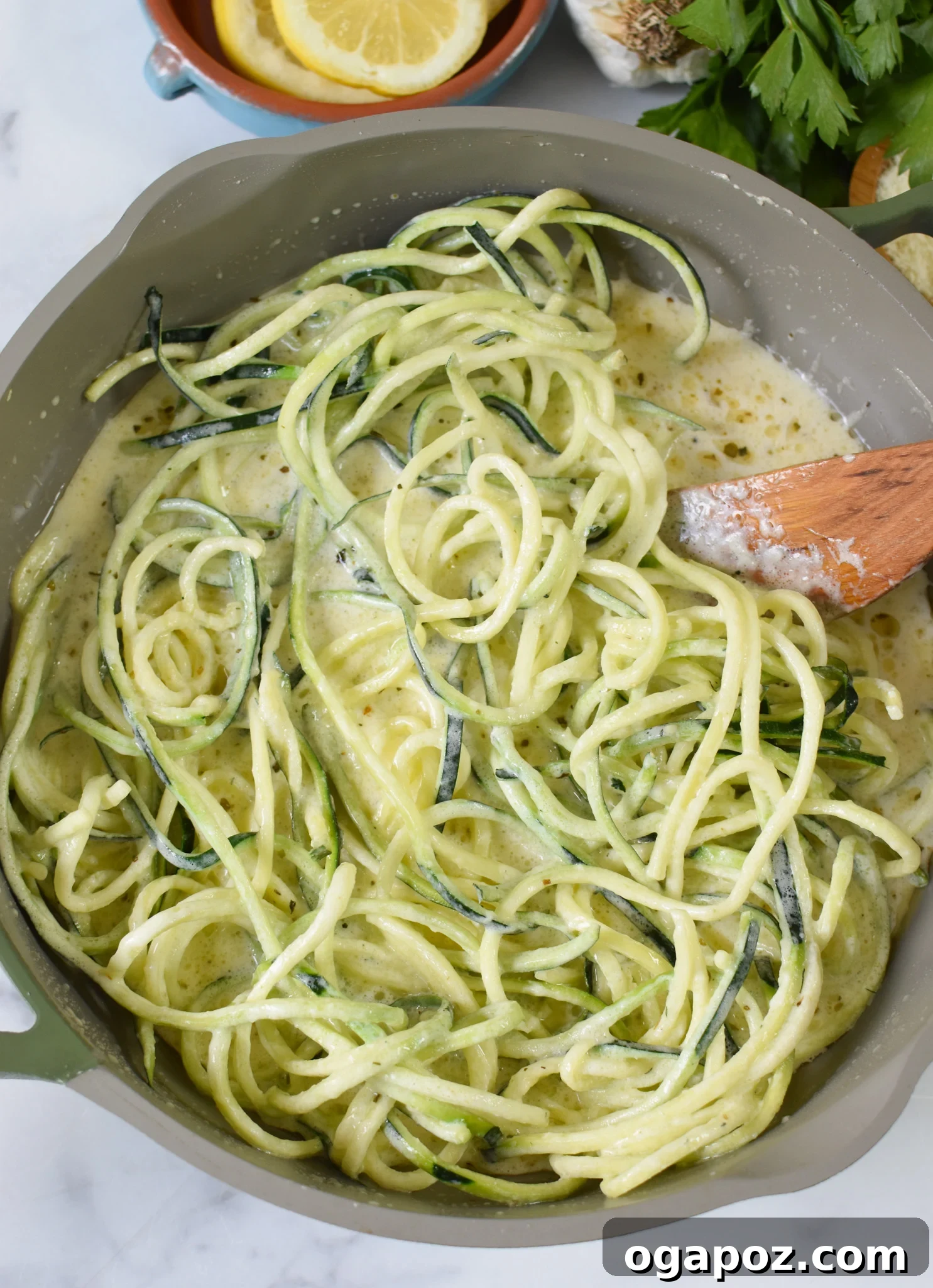 Creamy Zucchini Noodle Alfredo 6 Alfredo Zoodles Recipe sauce with zoodles, cooking in a pan.