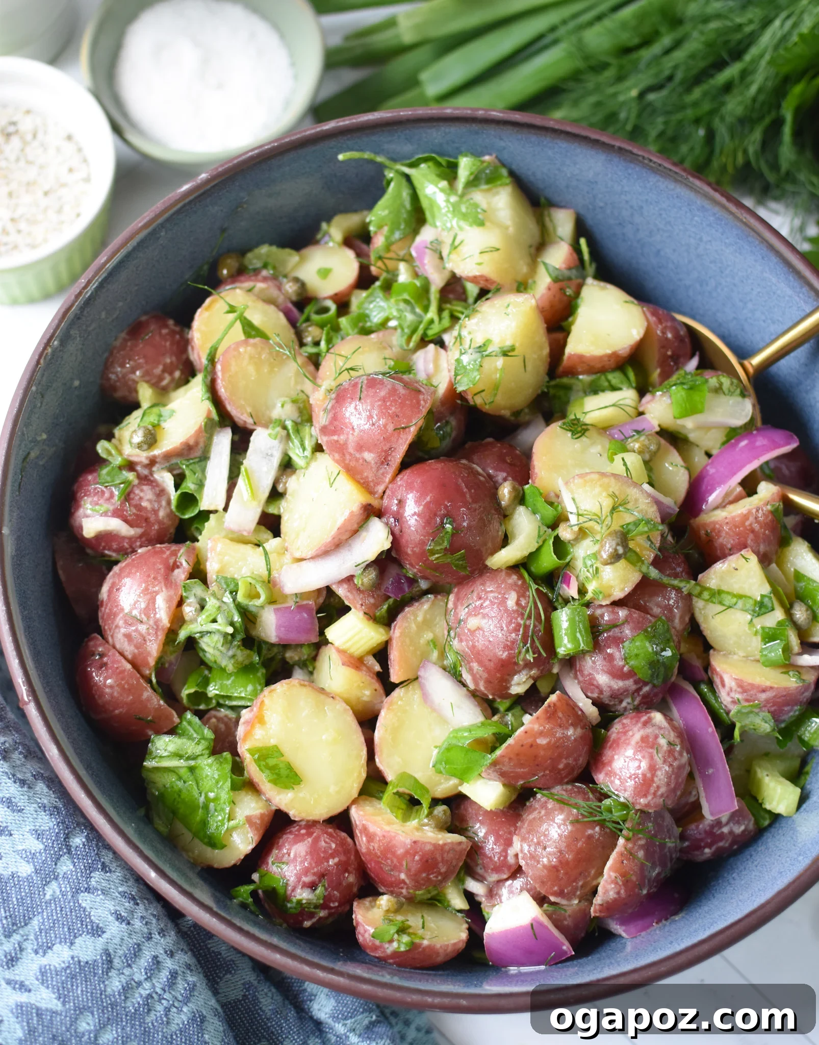 Bright and Tangy Potato Salad 8 No Mayo Potato Salad served in a beautiful blue bowl, ready for a gathering.
