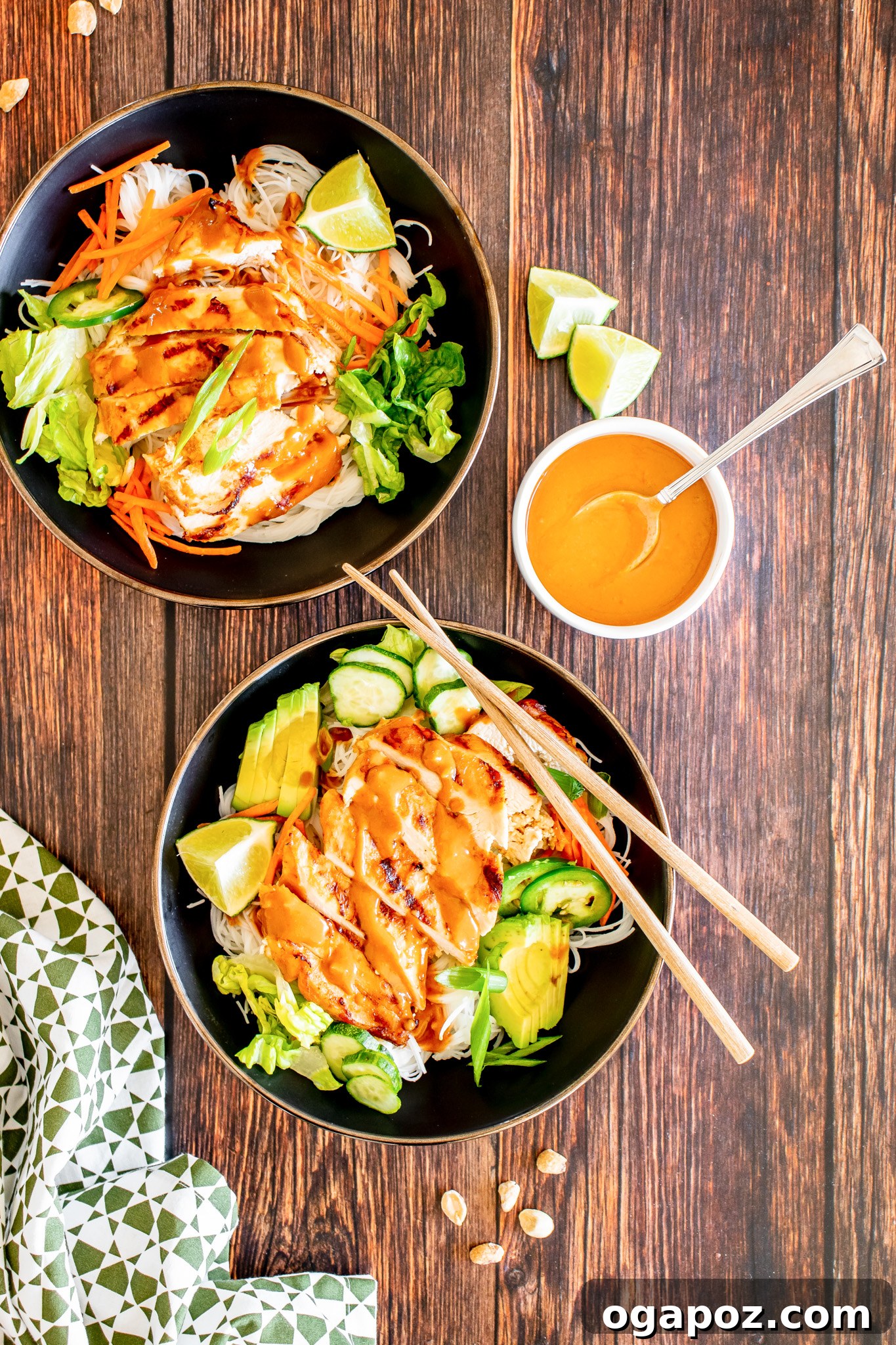 Vibrant Thai Chicken Noodle Salad 11 A close-up of Thai Chicken Noodle Salad in a bowl being drizzled with a rich peanut dressing.