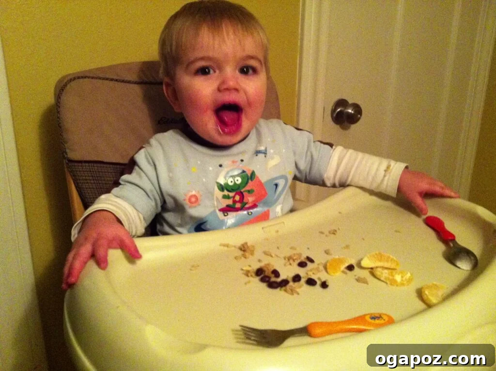 Toddler exploring food with a big smile