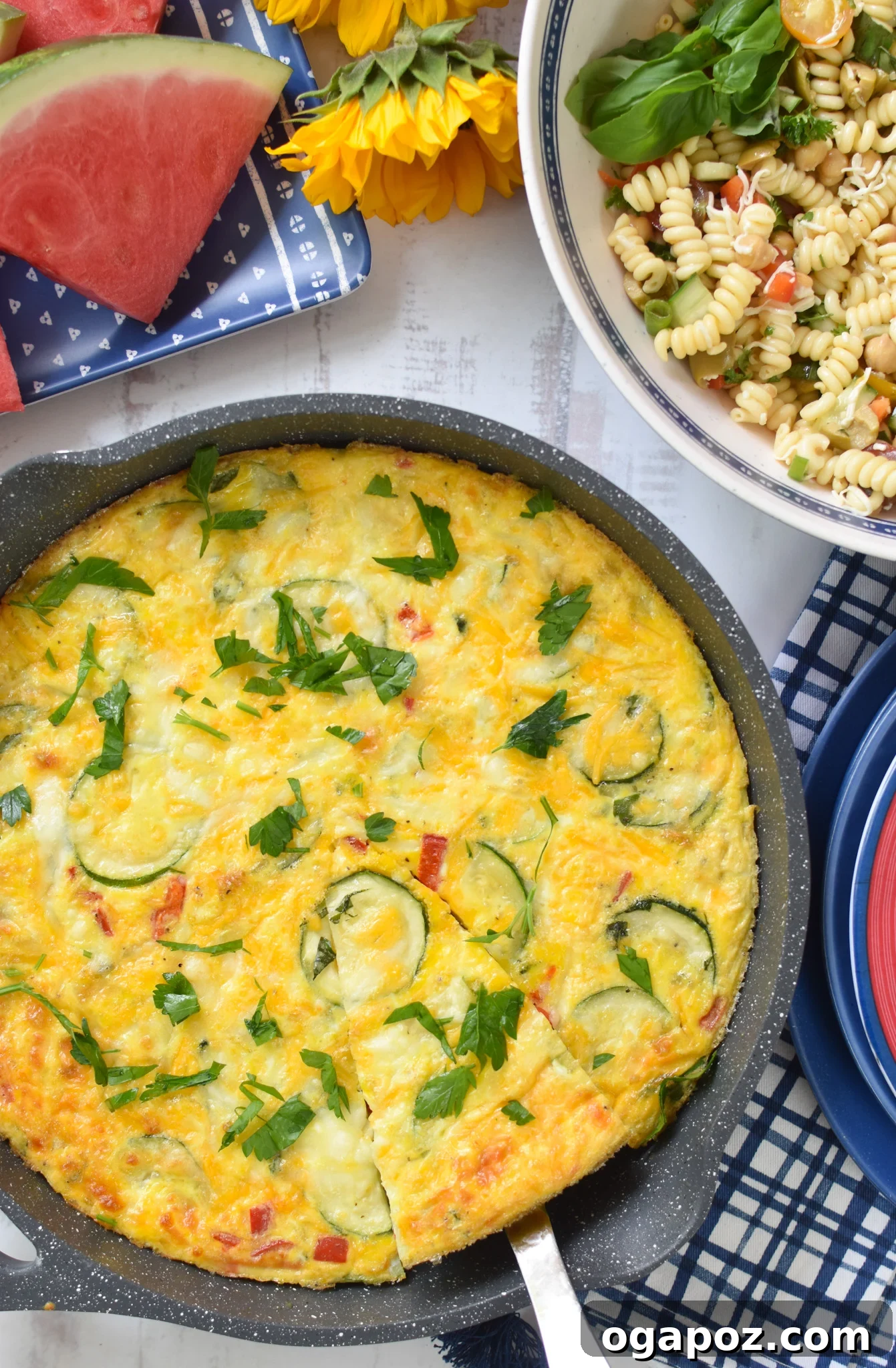 Golden Zucchini Frittata 2 Zucchini Frittata Recipe in a skillet with blue napkins.