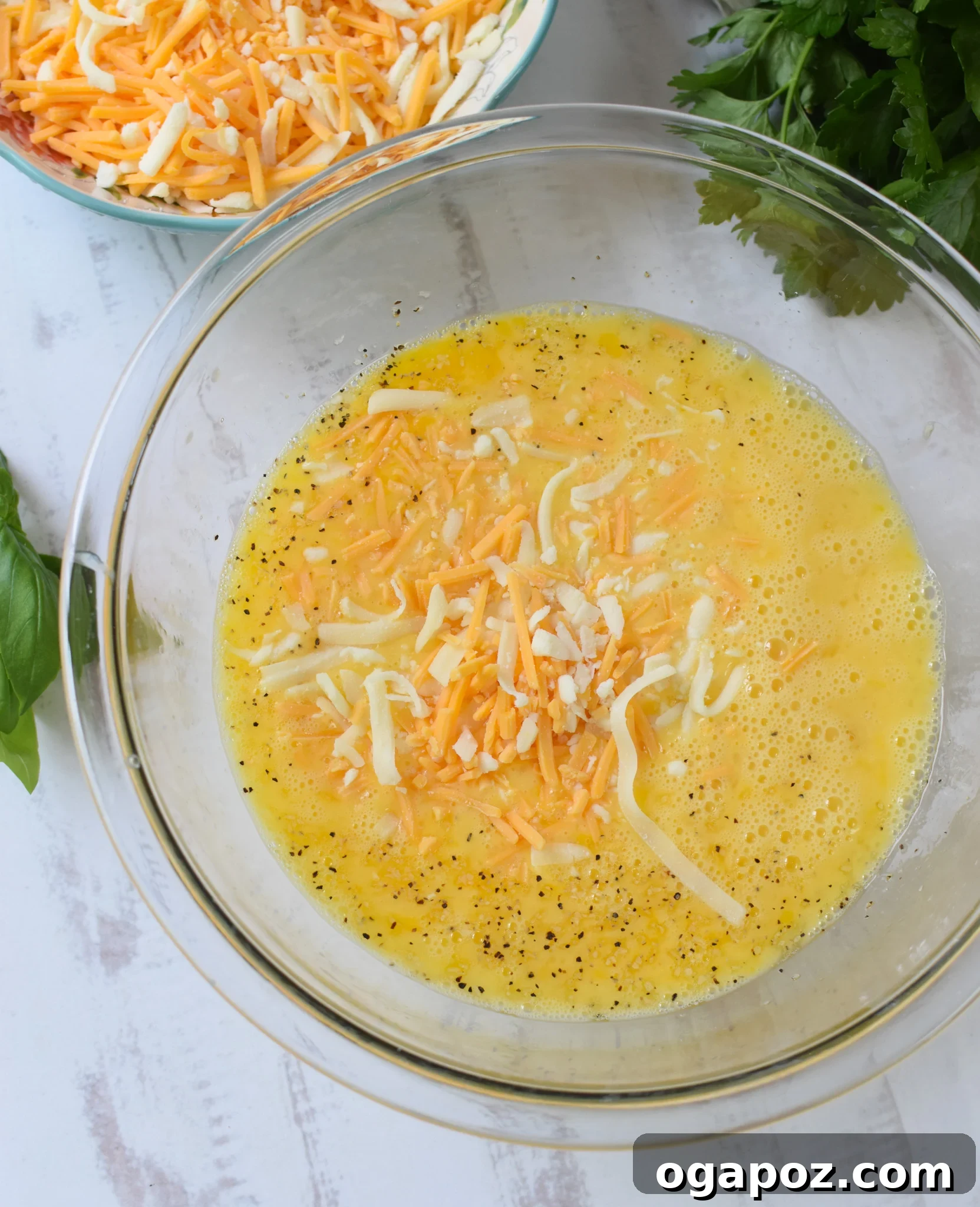 Golden Zucchini Frittata 10 Zucchini Frittata Recipe with cheese and eggs in bowl.