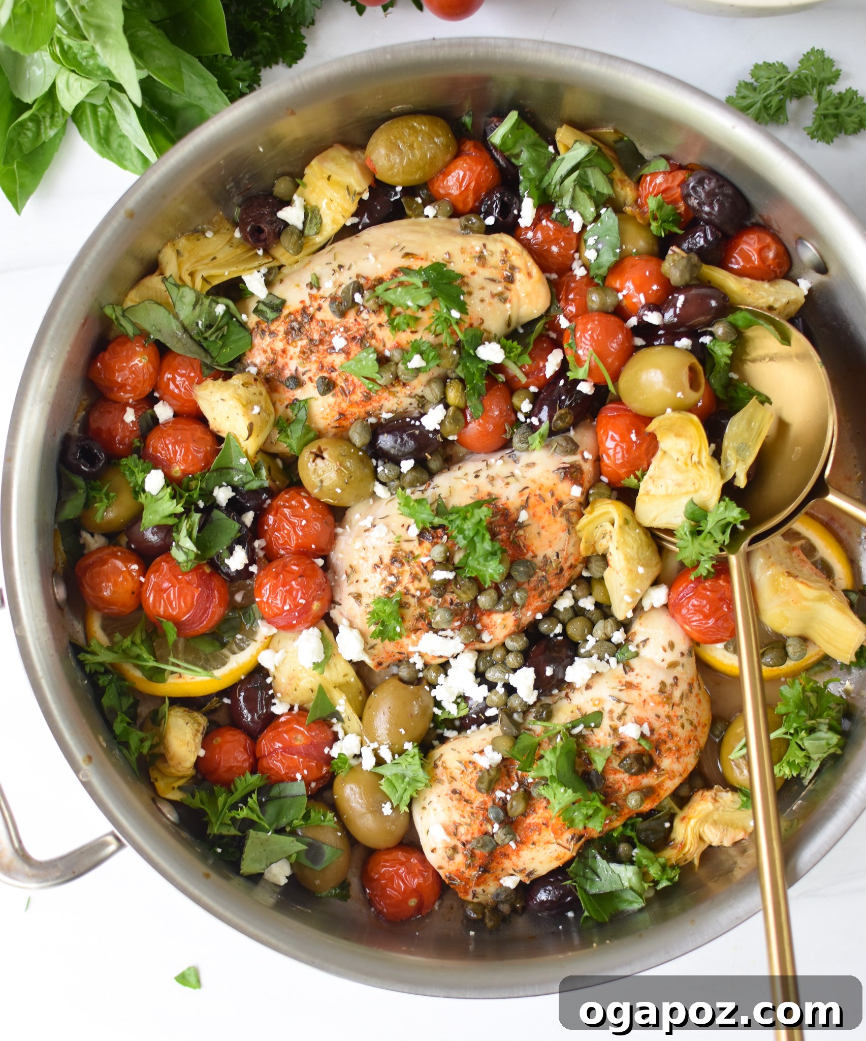 Vibrant Mediterranean Skillet Chicken 2 Mediterranean Skillet Chicken in a skillet with fork and spoon, ready to serve.
