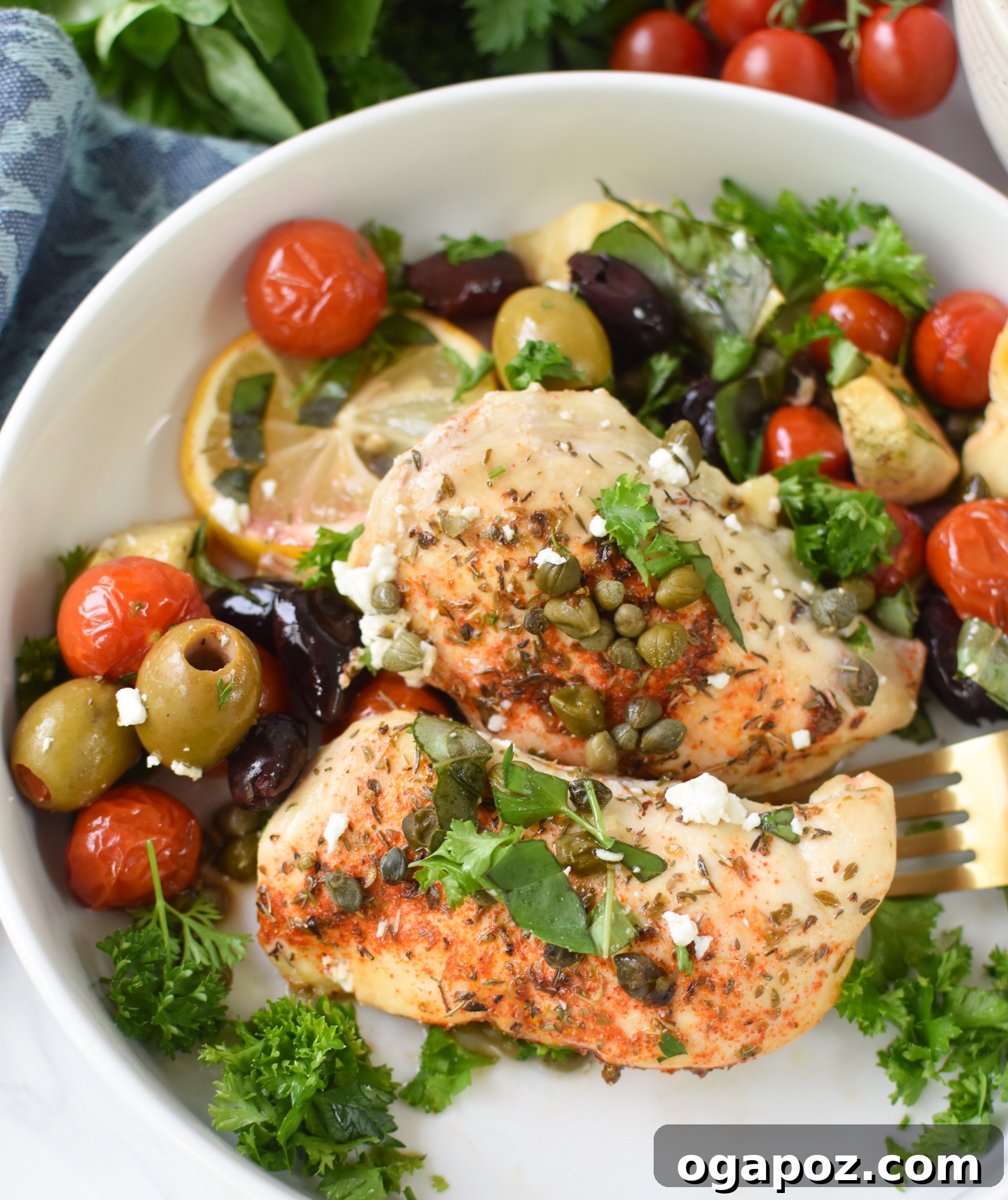 Vibrant Mediterranean Skillet Chicken 3 A serving of Mediterranean Skillet Chicken in a white bowl, garnished with fresh herbs.