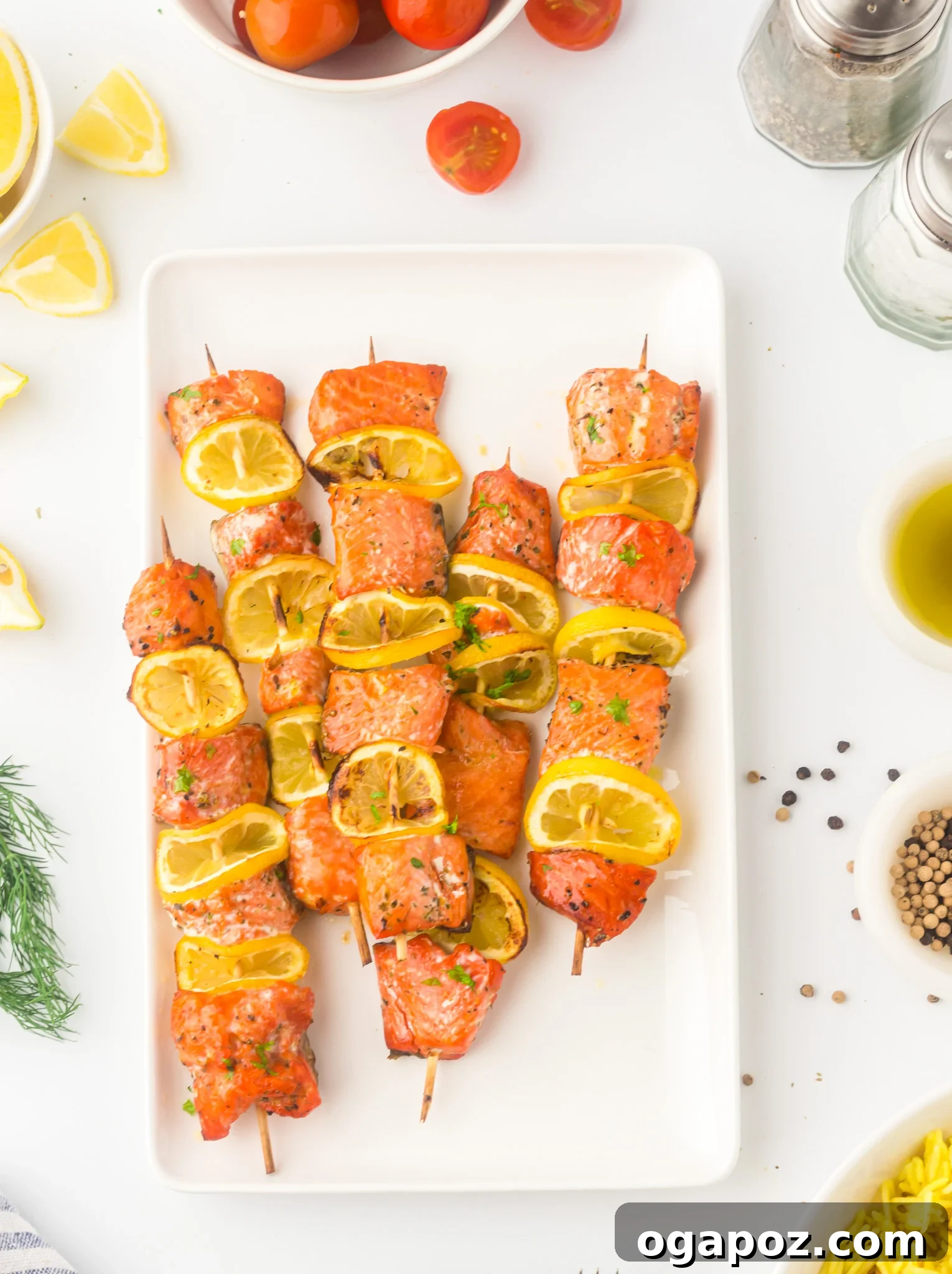 Quick Zesty Salmon Skewers 2 Easy Lemon Salmon Kabobs beautifully arranged on a white platter, garnished with fresh lemon slices and herbs.