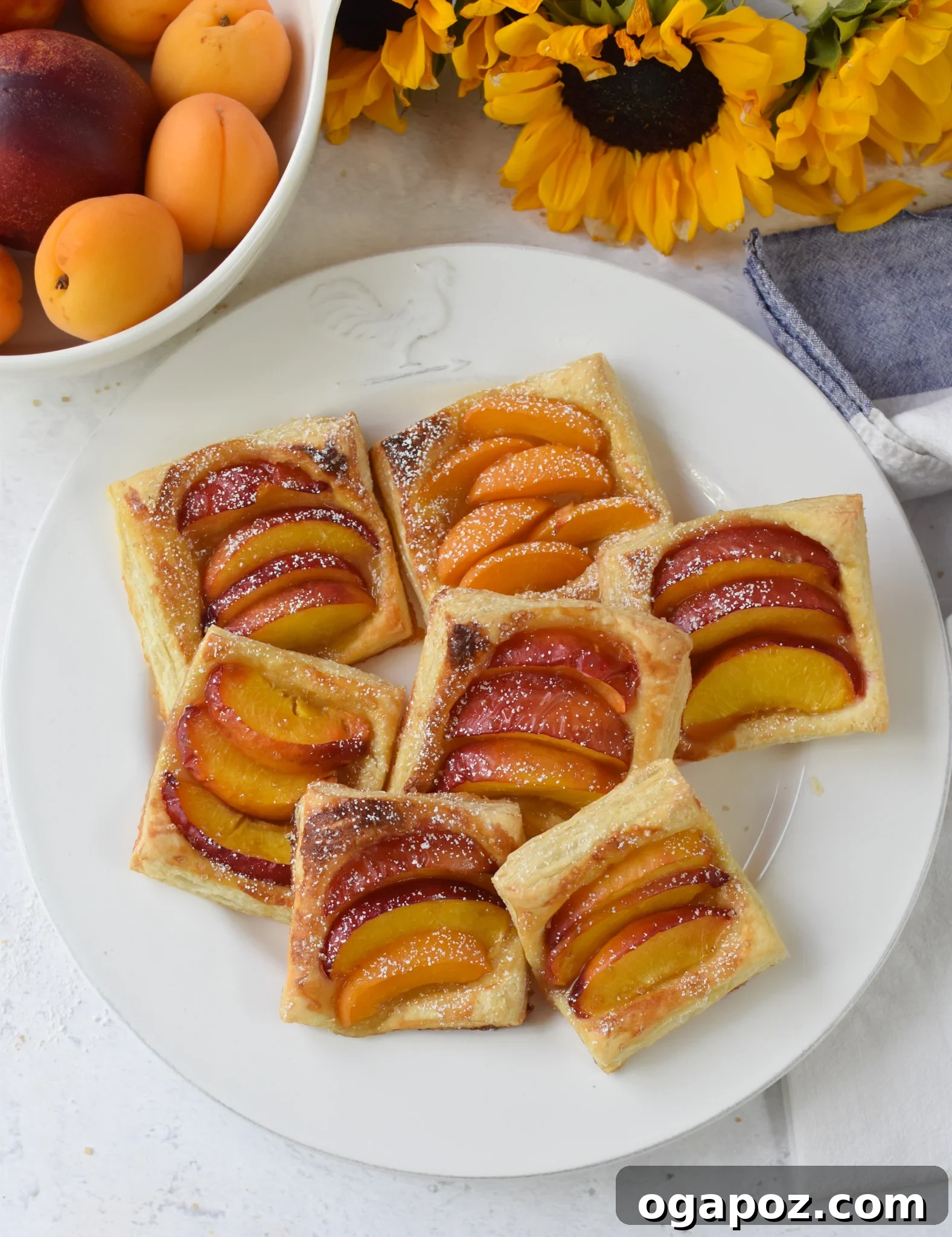 Effortless Golden Peach Tart 2 A beautifully golden Easy Peach Tart on a white plate, showcasing ripe peach slices and a flaky, golden crust. A perfect summer treat.