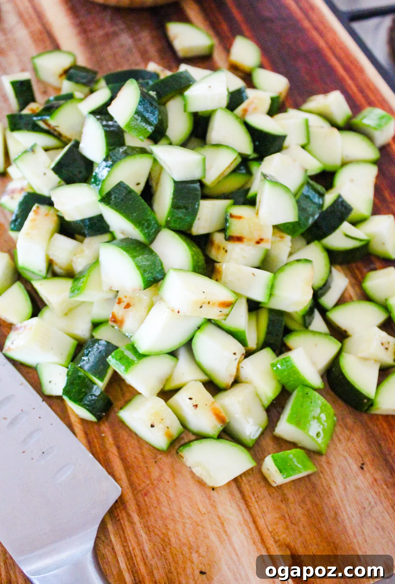 Effortless Zucchini Tacos 6 Grilled zucchini being chopped on a wooden cutting board.