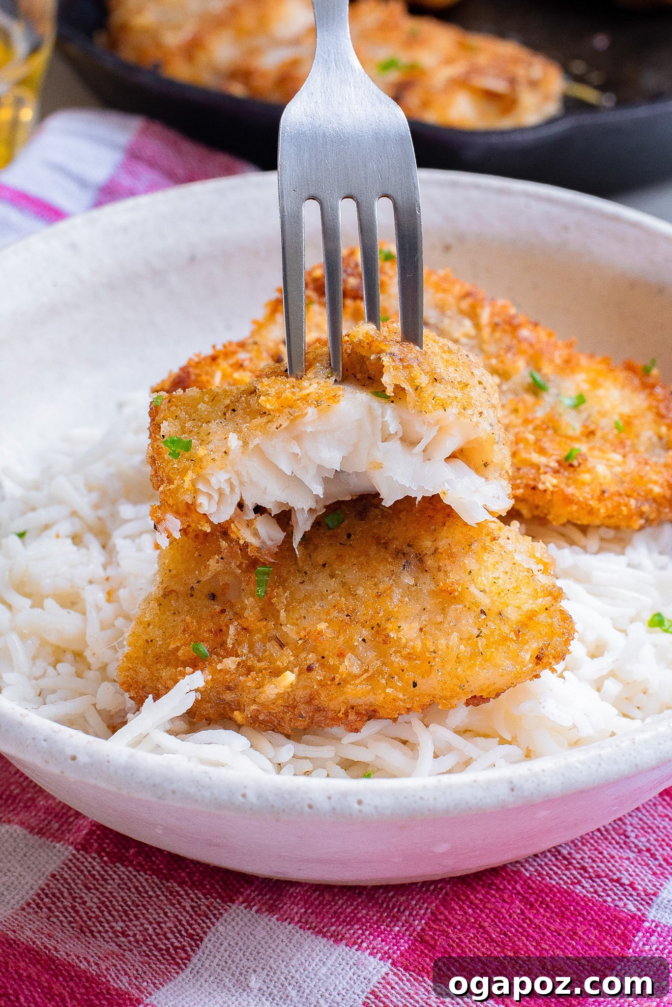 One-Pan Fish Perfection 2 Easy Pan-Fried Fish with fork, showing its golden, crispy exterior and flaky texture.