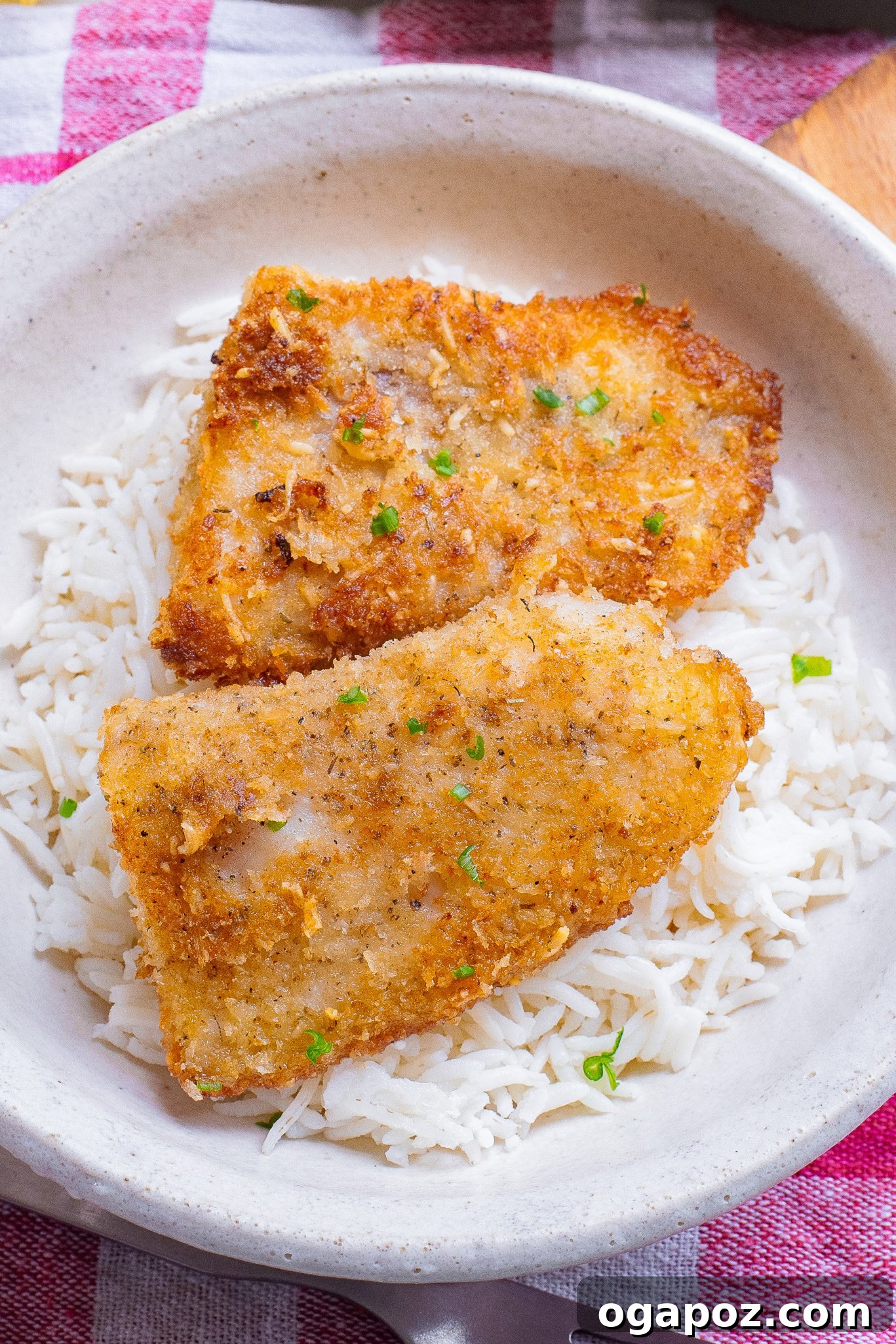 One-Pan Fish Perfection 4 Easy Pan-Fried Fish served in a white bowl with lemon and parsley garnish.