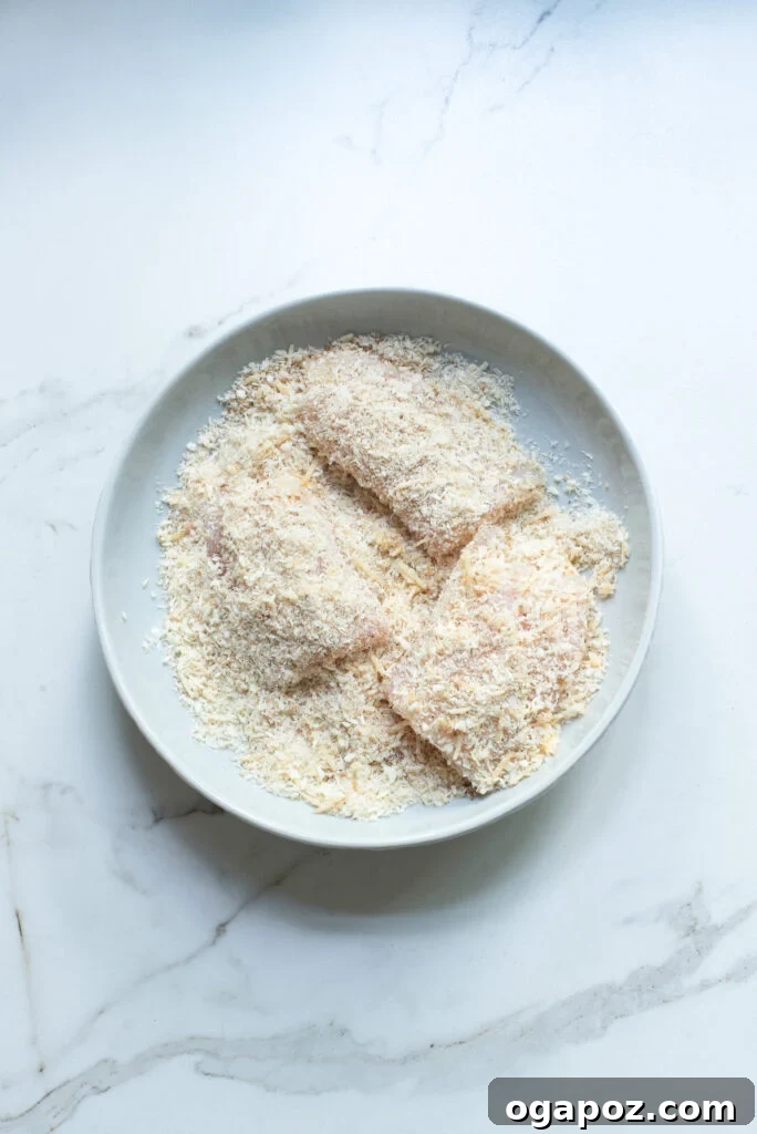 One-Pan Fish Perfection 6 Easy Pan-Fried Fish fillet being pressed into breadcrumbs.
