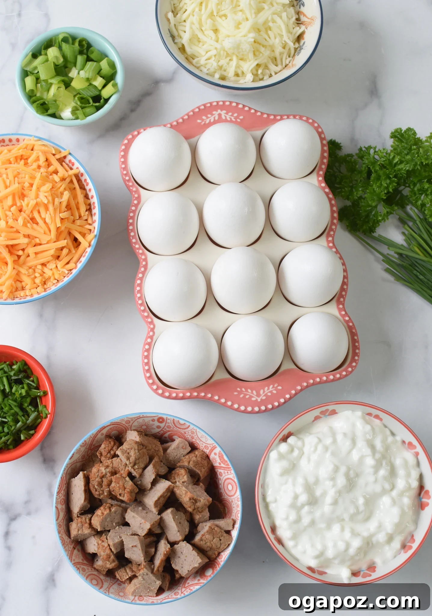 Savory Cottage Cheese Egg Bake 3 A vibrant display of all the fresh ingredients needed for Cottage Cheese Baked Eggs, including eggs, cheeses, cottage cheese, seasonings, and fresh chives.