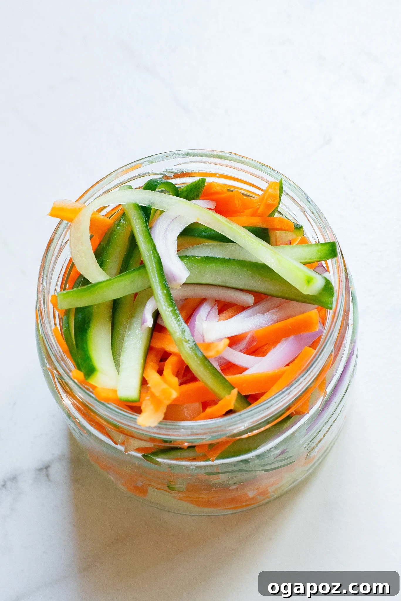 Fresh and Fast Pickles 7 A mason jar filled with colorful Quick Pickled Vegetables sits on a rustic wooden surface, ready for the fridge.