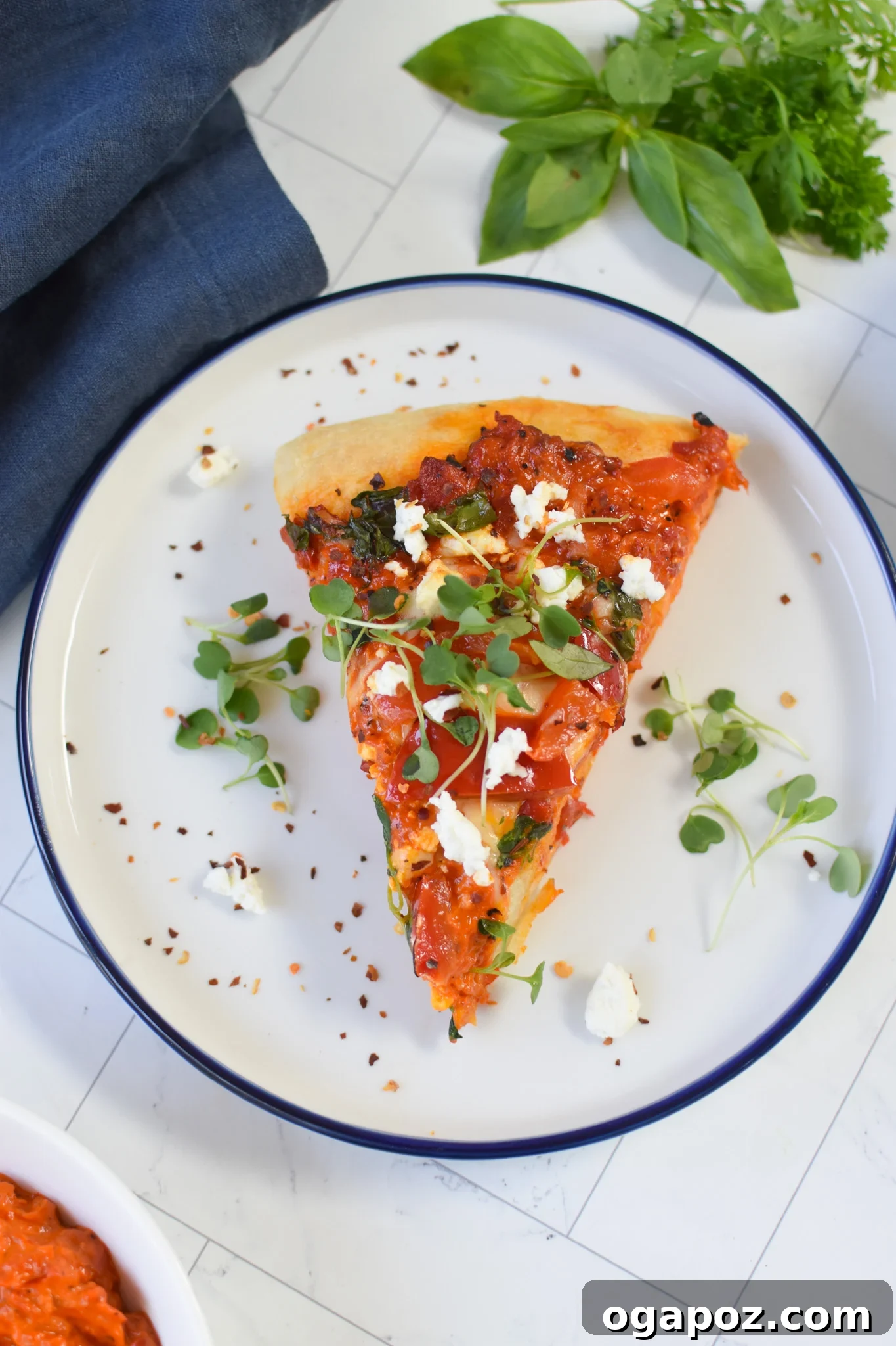 Sun-Kissed Mediterranean Skillet Pizza 9 A perfectly cooked slice of Cast Iron Mediterranean Pizza on a white plate, highlighting its golden crust and delicious toppings.