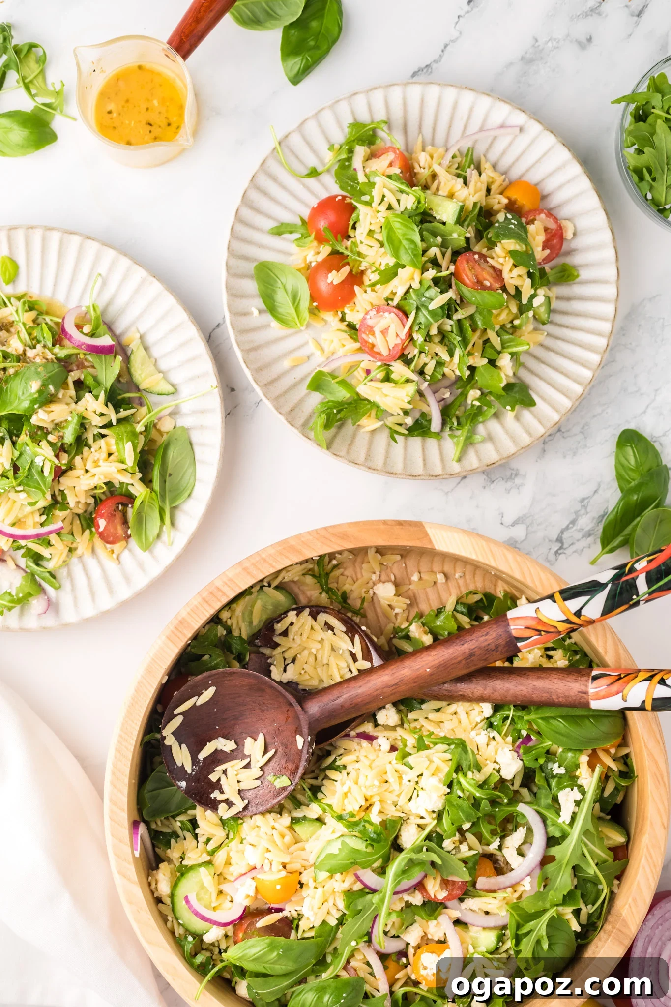 Vibrant Arugula Orzo Salad 8 Multiple white plates with individual servings of Arugula Orzo Salad.