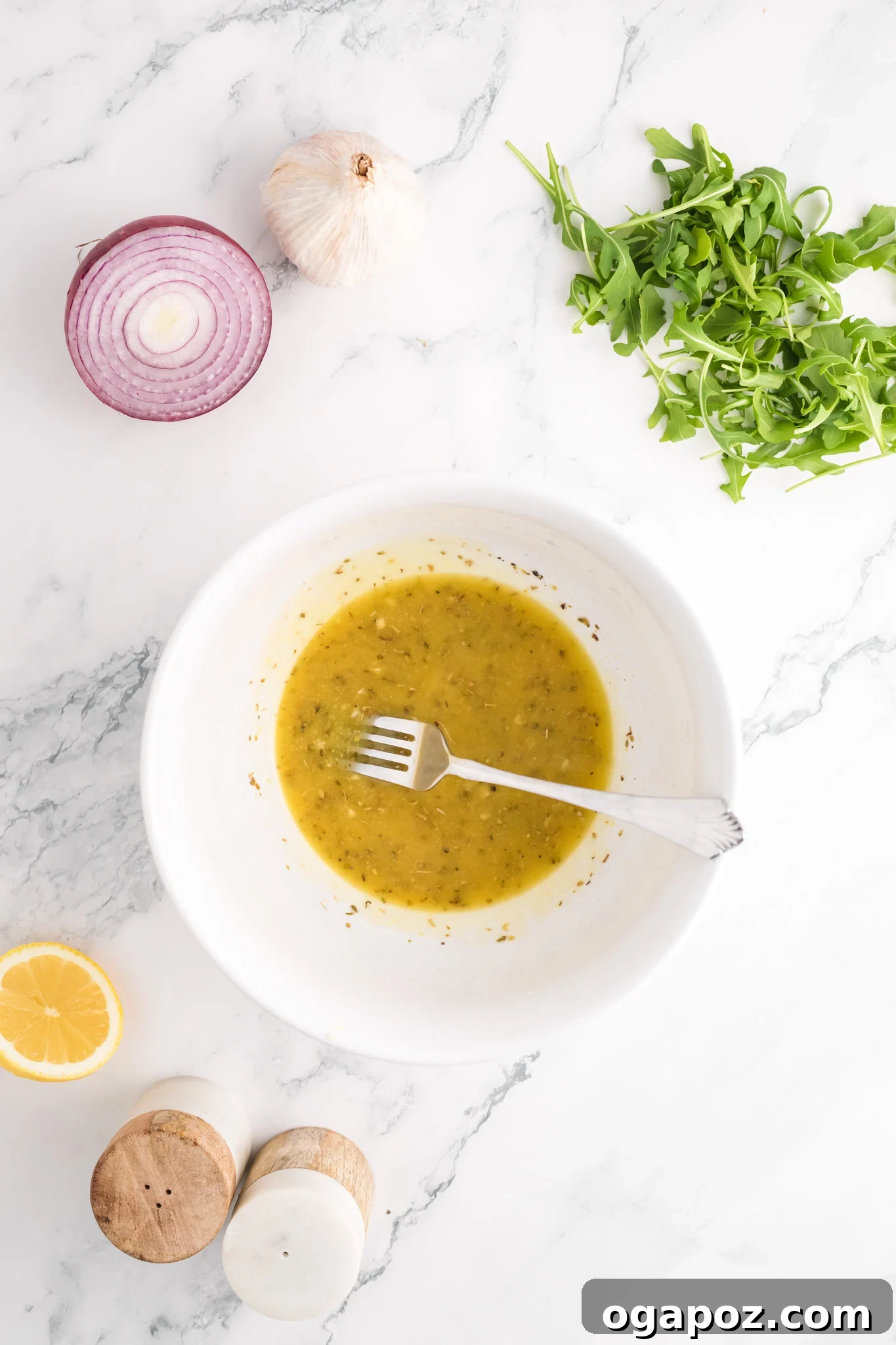 Vibrant Arugula Orzo Salad 9 Homemade Greek salad dressing in a small glass bowl.