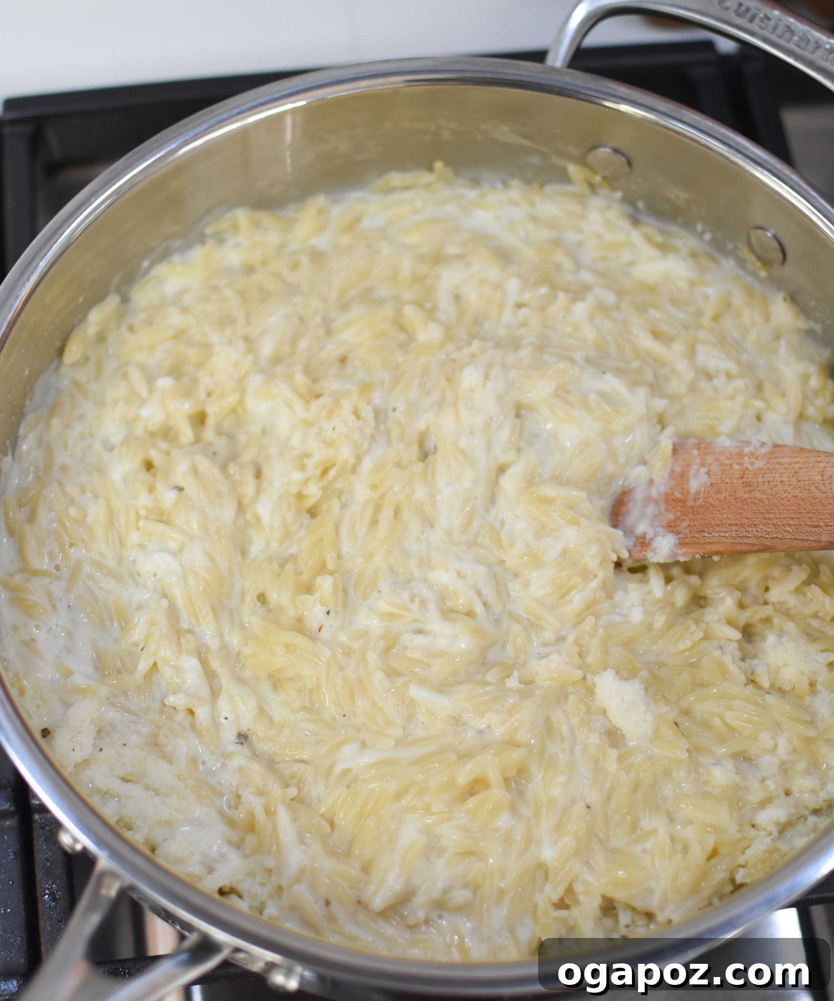 Bright Lemon Chicken Orzo 9 Sauce ingredients for Lemon Chicken Orzo being stirred in a pan.