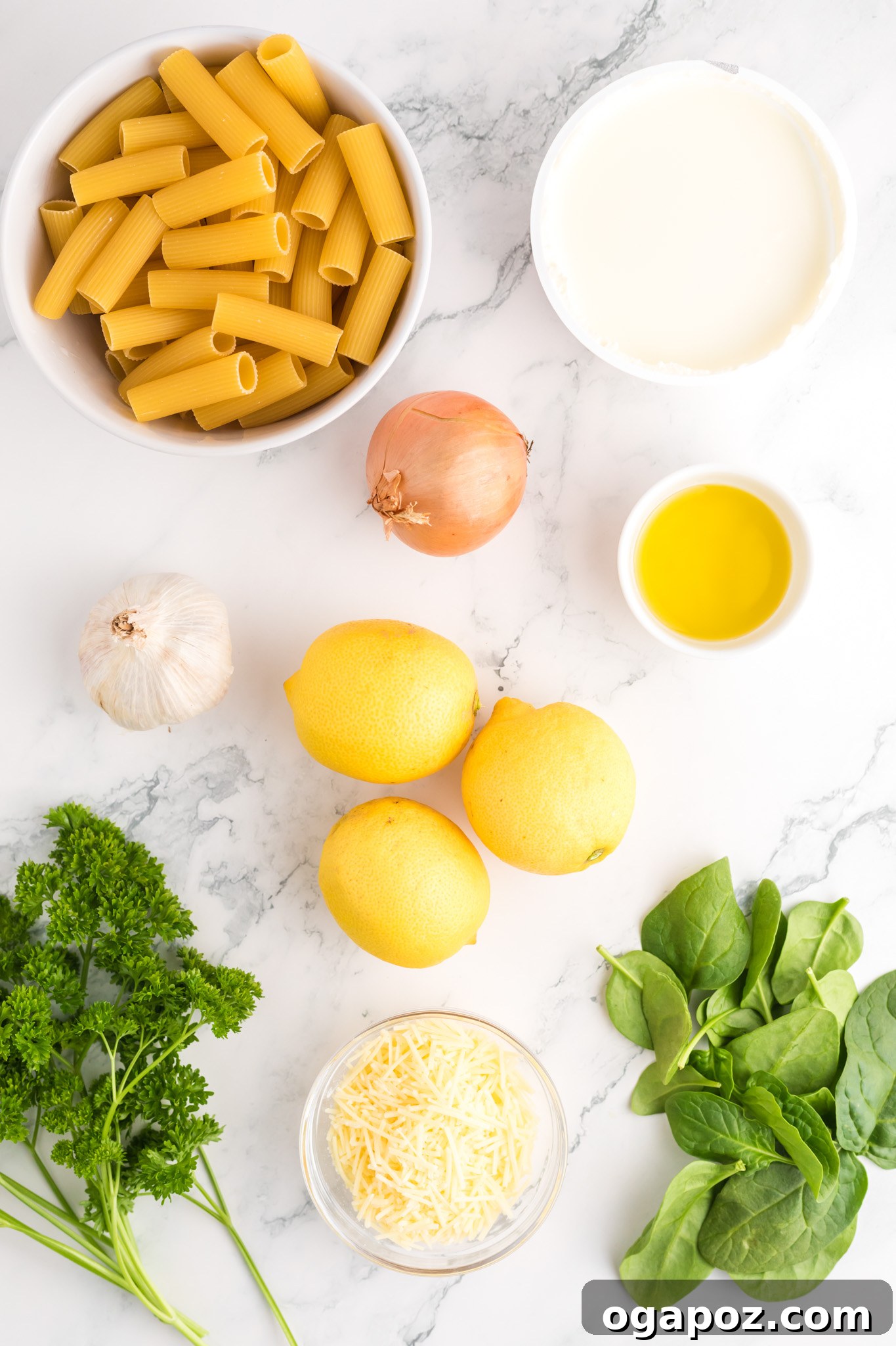 Velvety Lemon Ricotta Pasta 4 All the fresh ingredients for Lemon Ricotta Pasta laid out on a wooden board: rigatoni, lemons, ricotta, spinach, Parmesan, shallots, garlic, and parsley, ready for preparation.