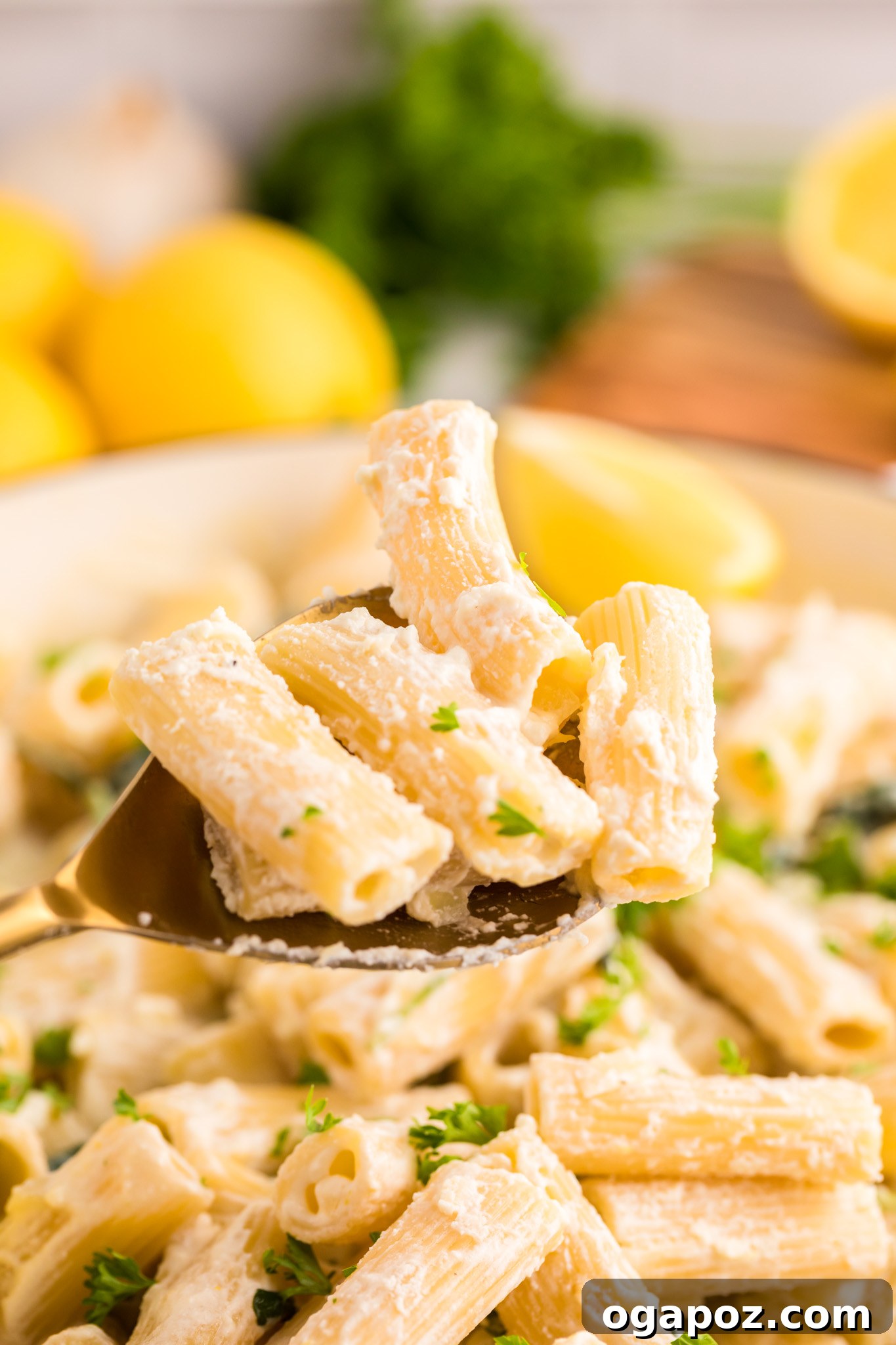 Velvety Lemon Ricotta Pasta 5 Lemon Ricotta Pasta being served with a serving spoon, highlighting the creamy sauce clinging perfectly to the pasta strands.