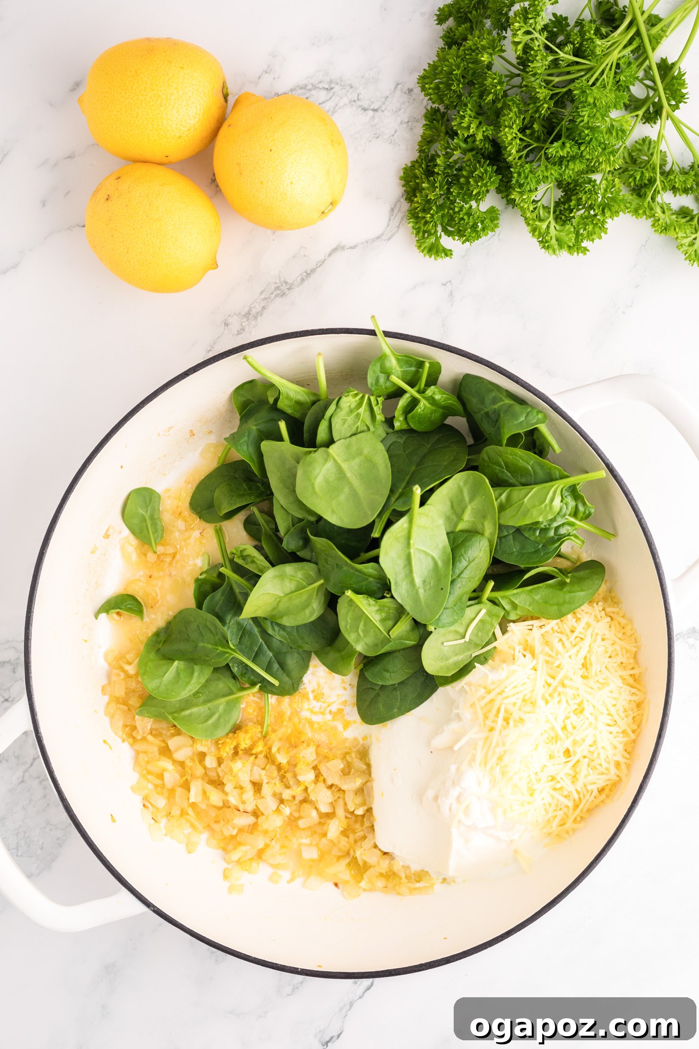 Velvety Lemon Ricotta Pasta 7 Lemon ricotta pasta sauce ingredients, including ricotta, heavy cream, lemon juice, lemon zest, spinach, and Parmesan, gently simmering in a skillet.
