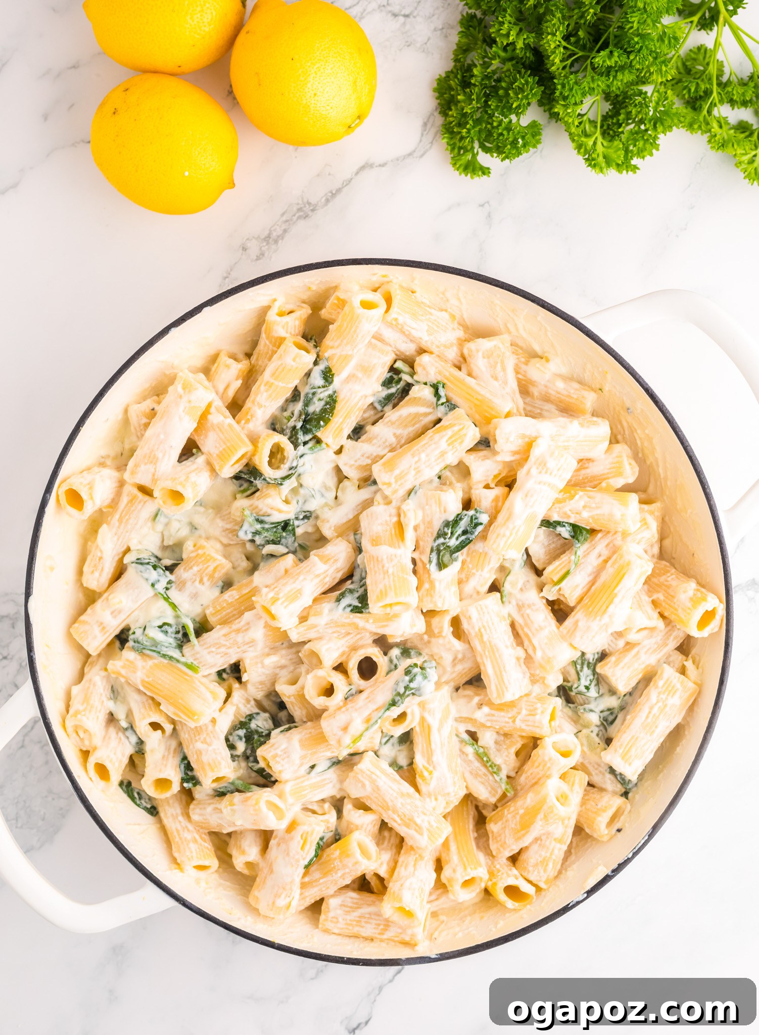 Velvety Lemon Ricotta Pasta 8 Finished Lemon Ricotta Pasta garnished generously with fresh parsley in a serving bowl, ready to be enjoyed.