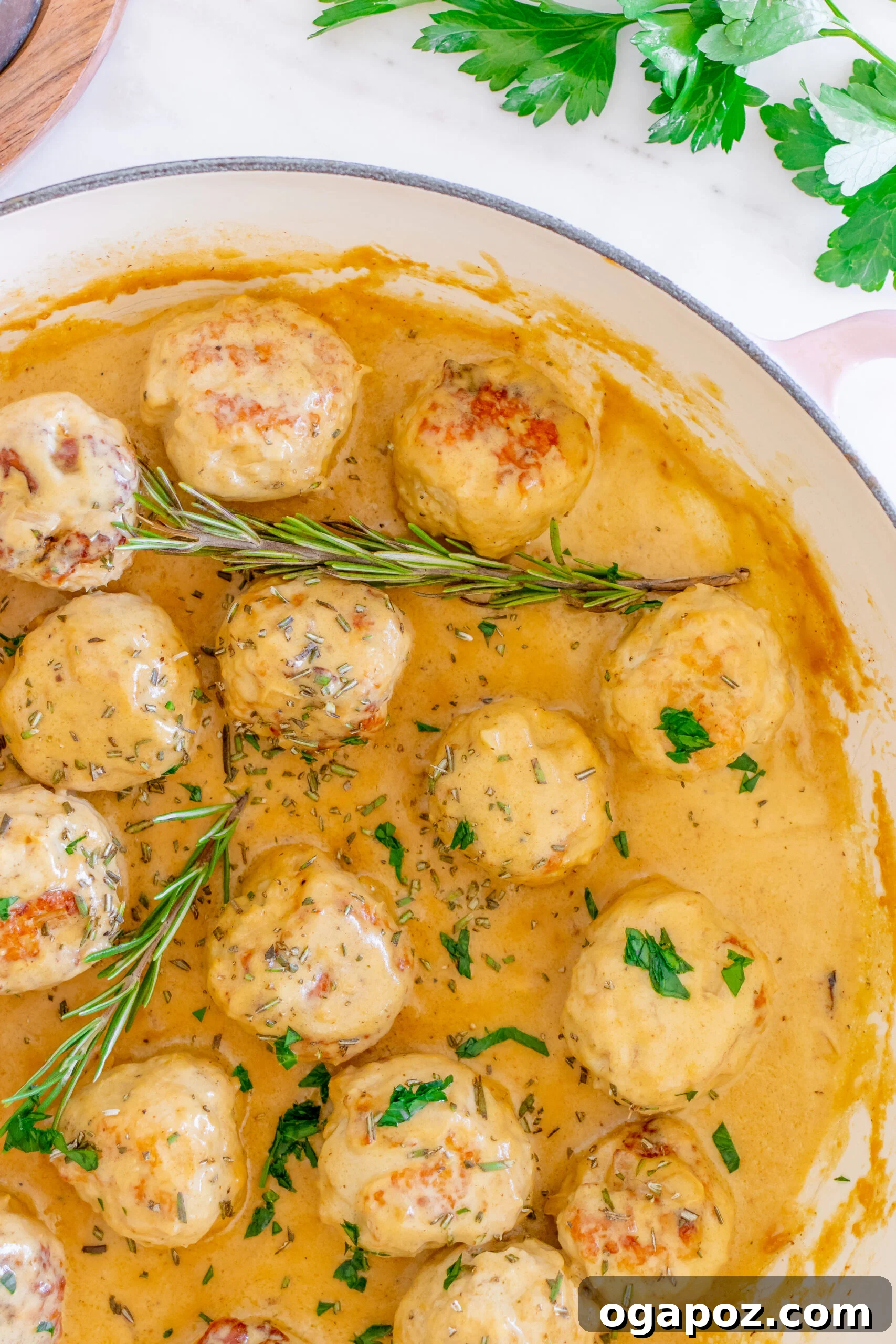 Sticky Maple Dijon Turkey Meatballs 7 Fresh rosemary sprigs laid on a cutting board, ready for the turkey meatballs.