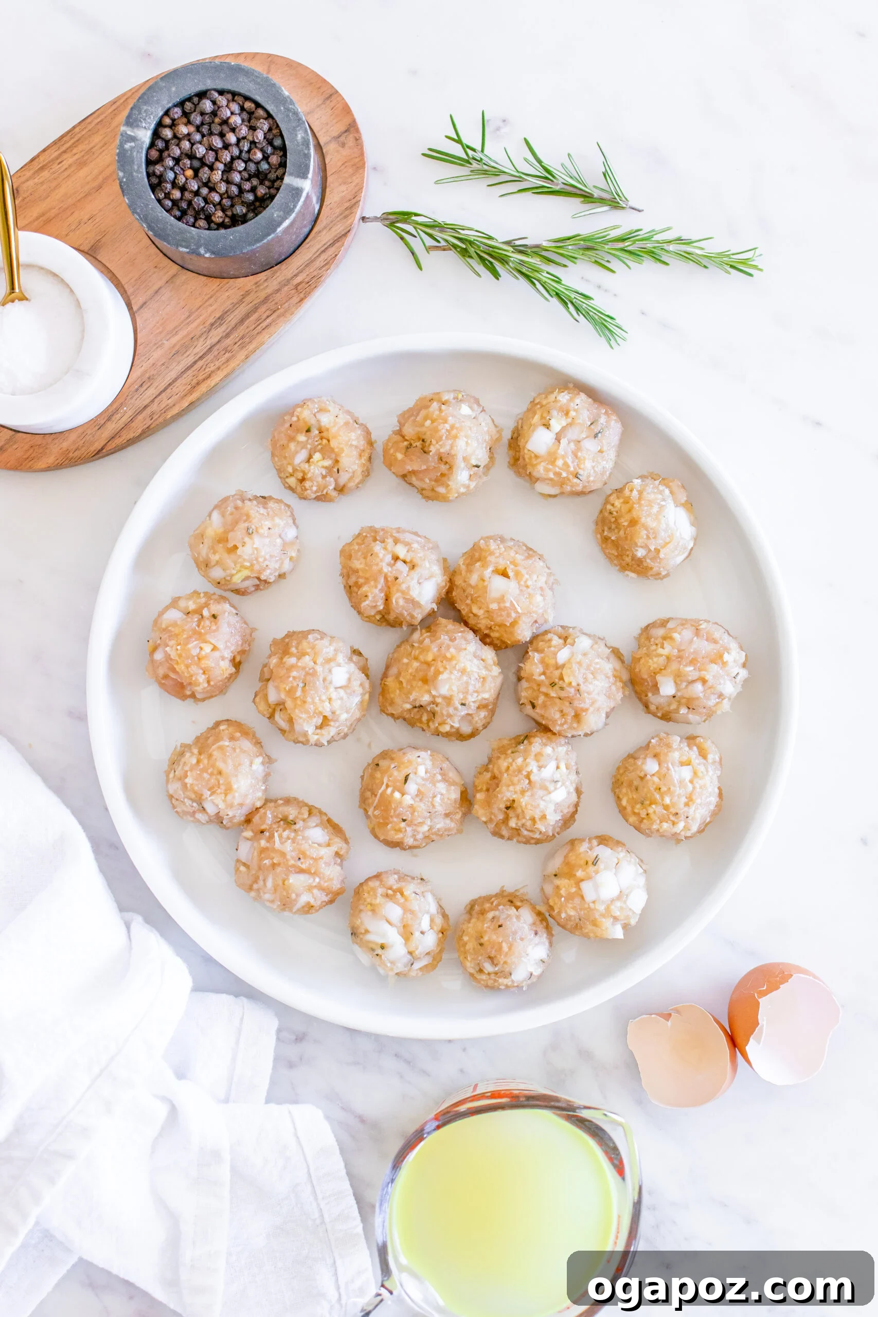 Sticky Maple Dijon Turkey Meatballs 9 Raw Maple Dijon Turkey Meatballs neatly arranged on a plate.