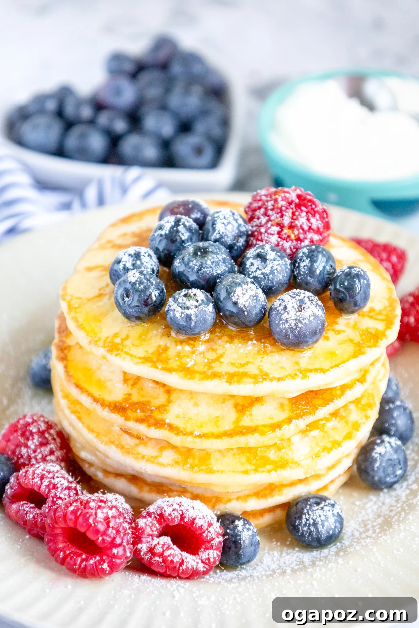 Fluffy Buttermilk Pancake Bliss 2 Homemade Buttermilk Pancakes with fresh blueberries and a drizzle of maple syrup.