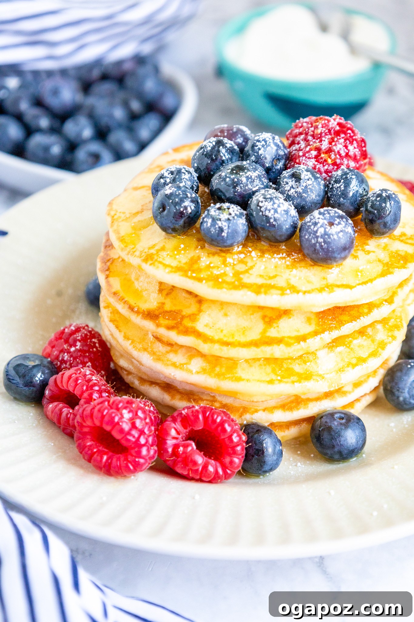 Fluffy Buttermilk Pancake Bliss 5 A beautifully plated stack of homemade buttermilk pancakes, dusted with powdered sugar, ready for enjoyment.