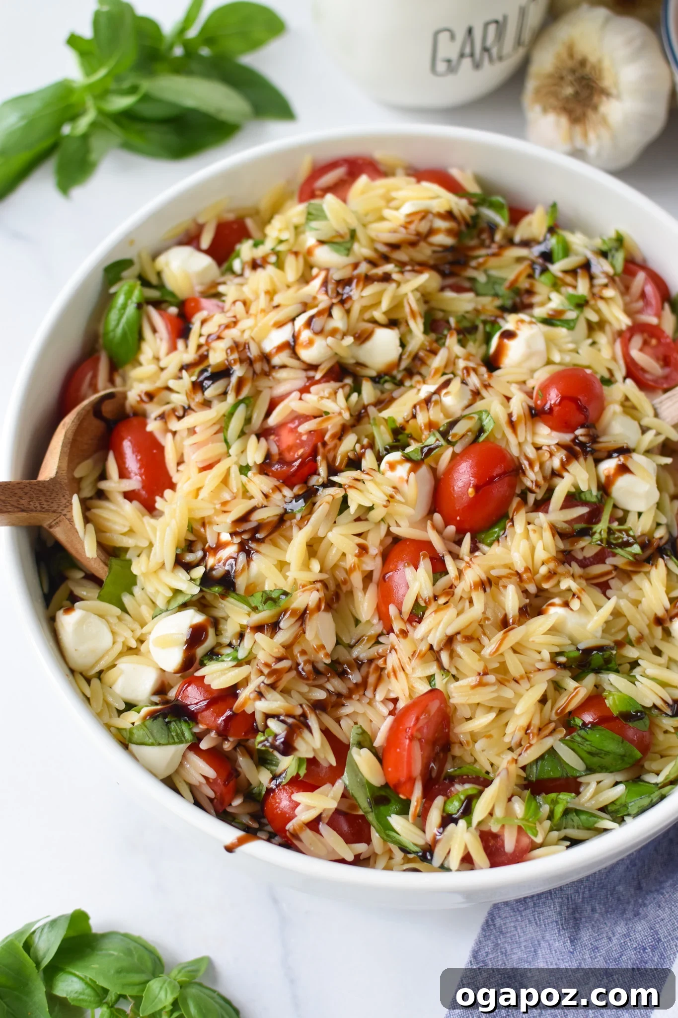 Fresh Caprese Orzo Salad 2 Caprese Orzo Pasta Salad with balsamic in a large bowl.