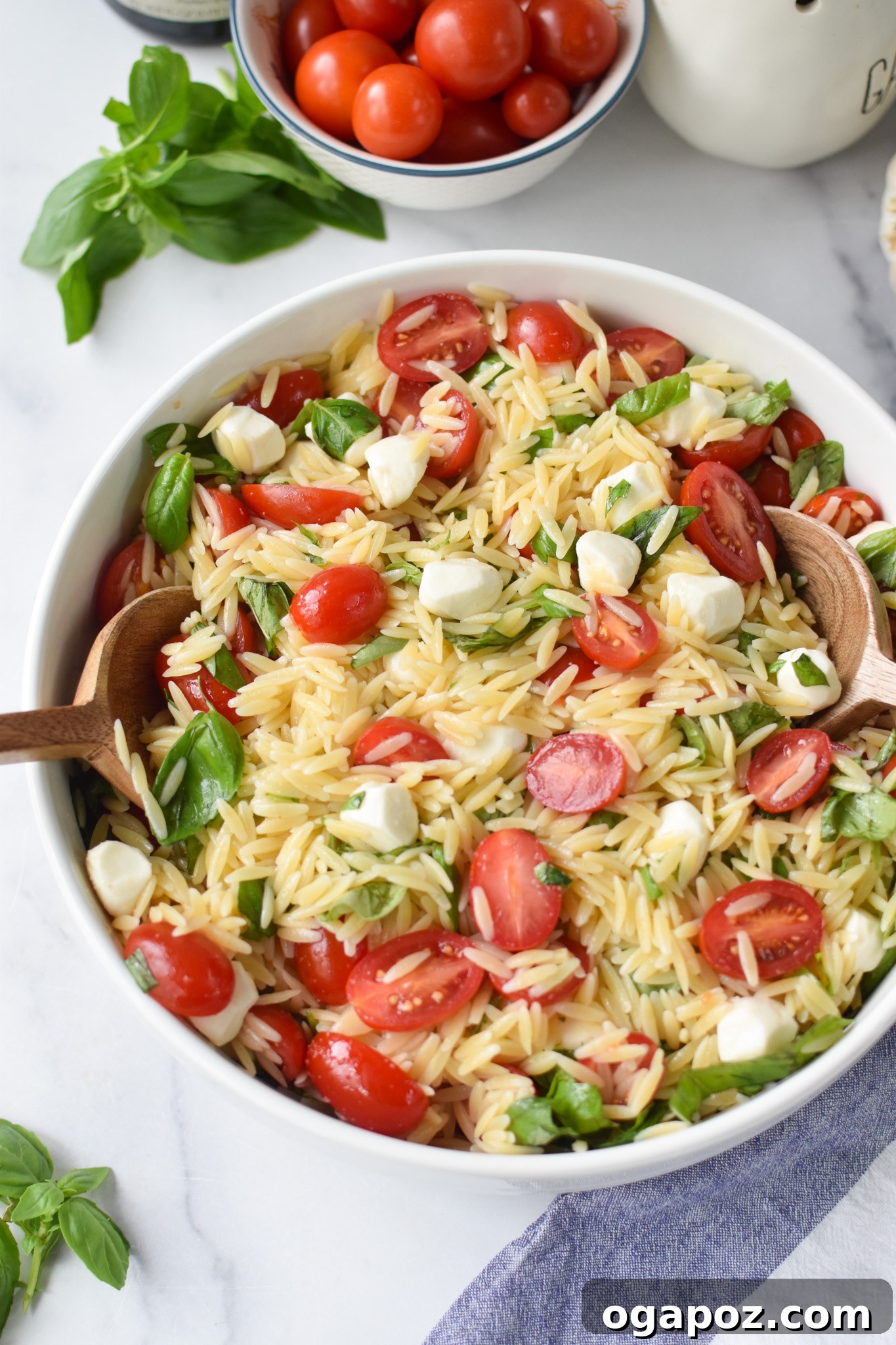 Fresh Caprese Orzo Salad 3 Caprese Orzo Pasta Salad with wooden spoons.