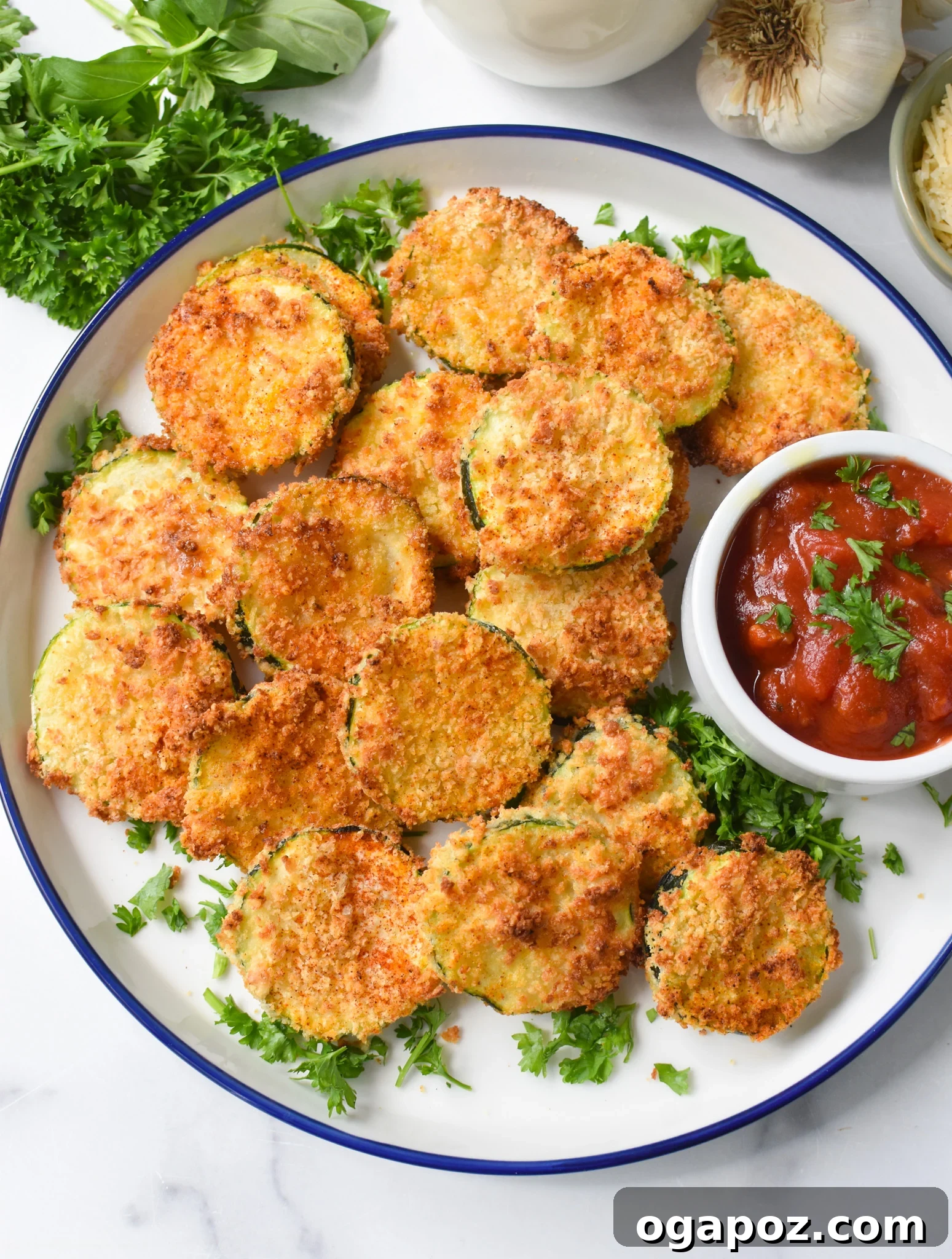 Crispy Air Fryer Zucchini Crisps 11 Air Fryer Zucchini Chips garnished with parsley, served with marinara sauce.