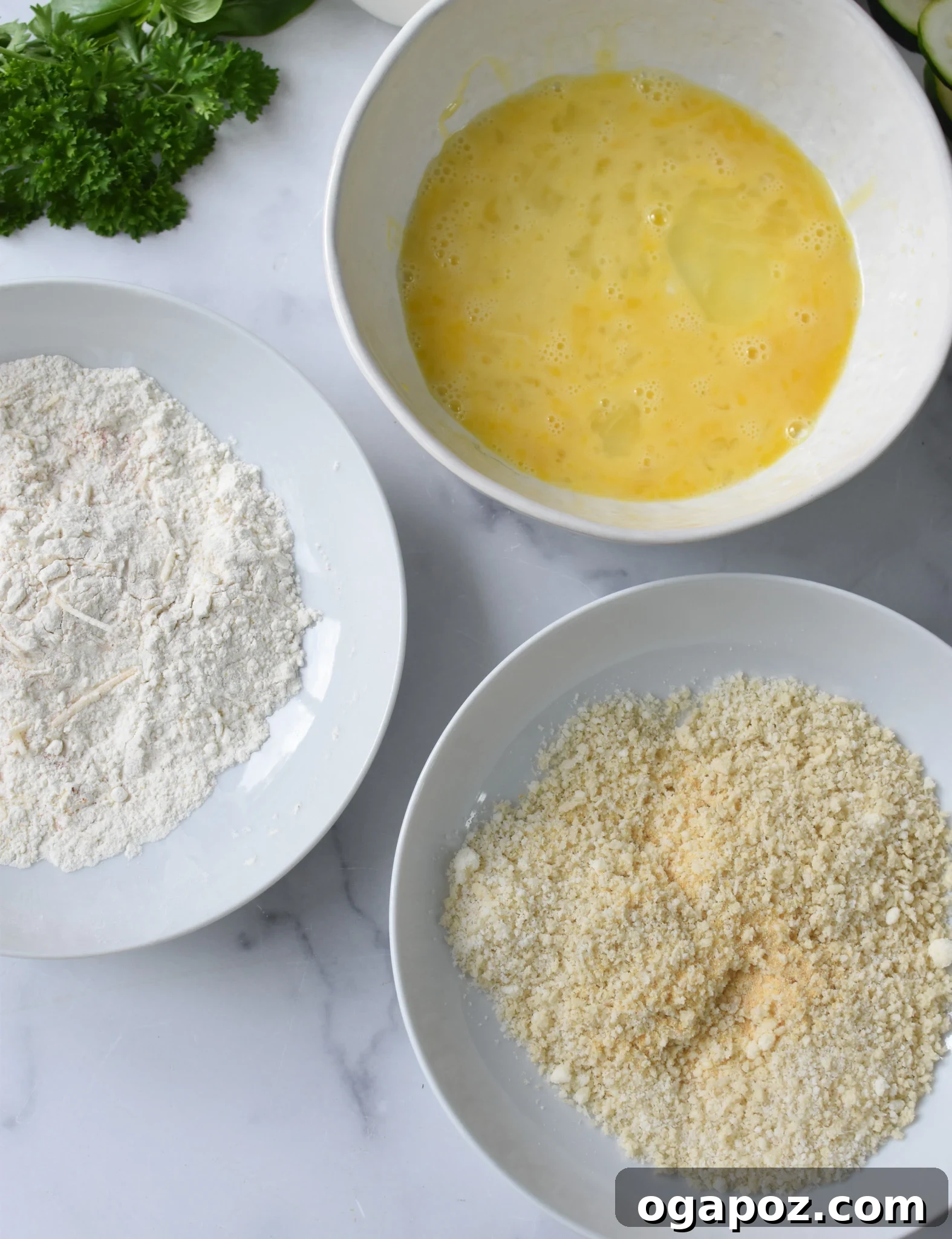 Crispy Air Fryer Zucchini Crisps 8 Three bowls showing the flour, egg, and breadcrumb mixtures for breading zucchini chips.