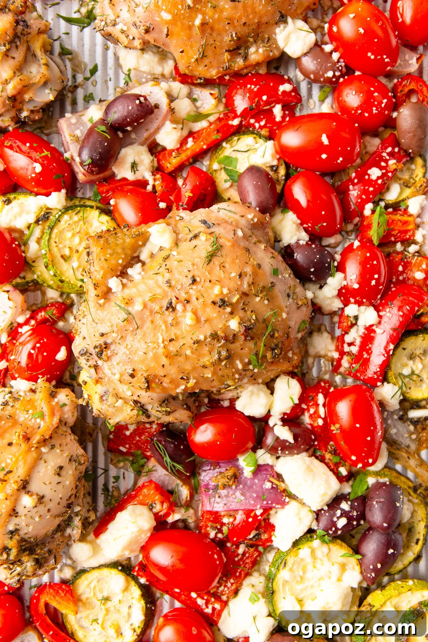 Zesty Mediterranean Sheet Pan Chicken 11 Mediterranean Sheet Pan Chicken with fresh herbs on a baking sheet after cooking.