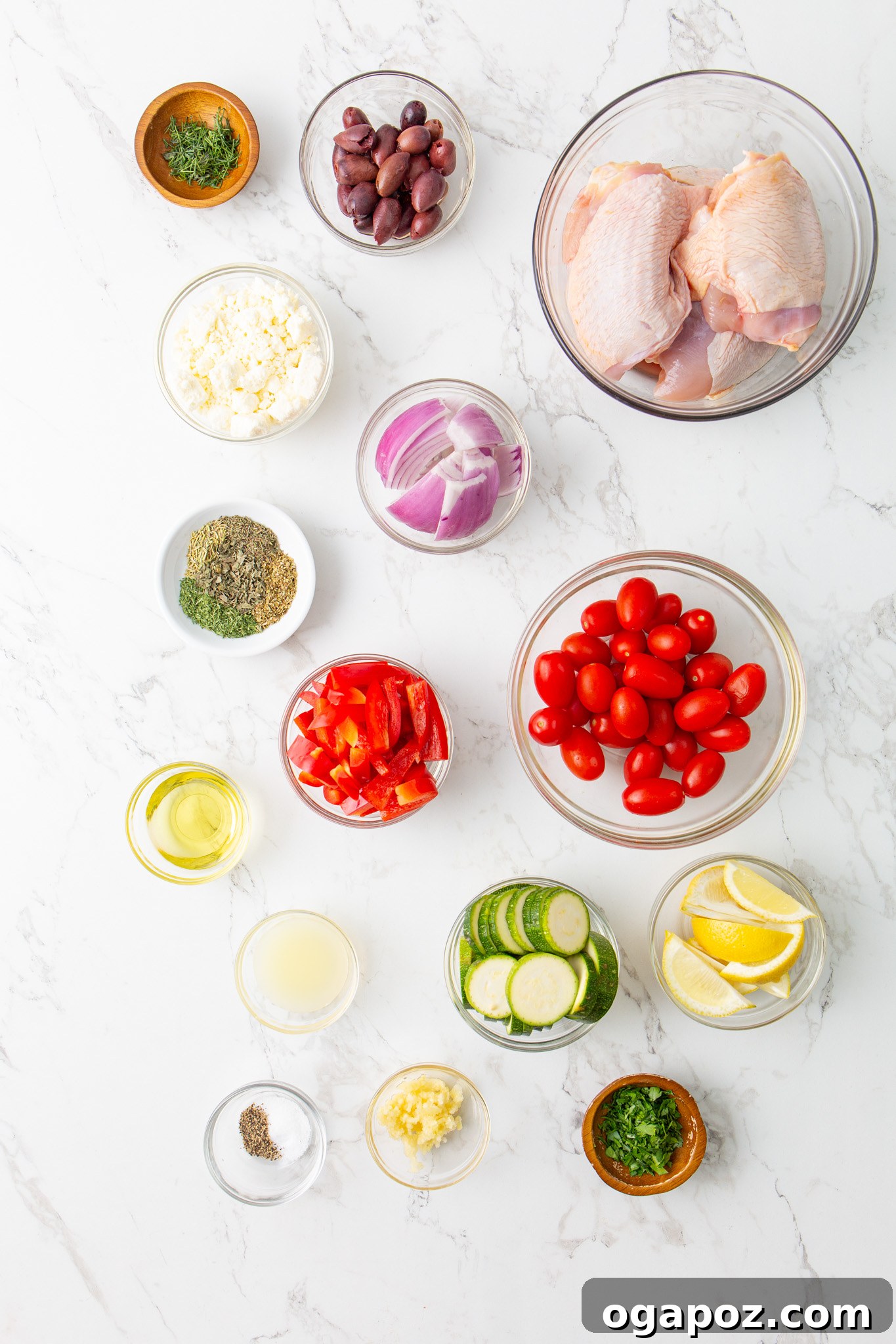 Zesty Mediterranean Sheet Pan Chicken 5 All the fresh ingredients for Mediterranean Sheet Pan Chicken laid out on a table.