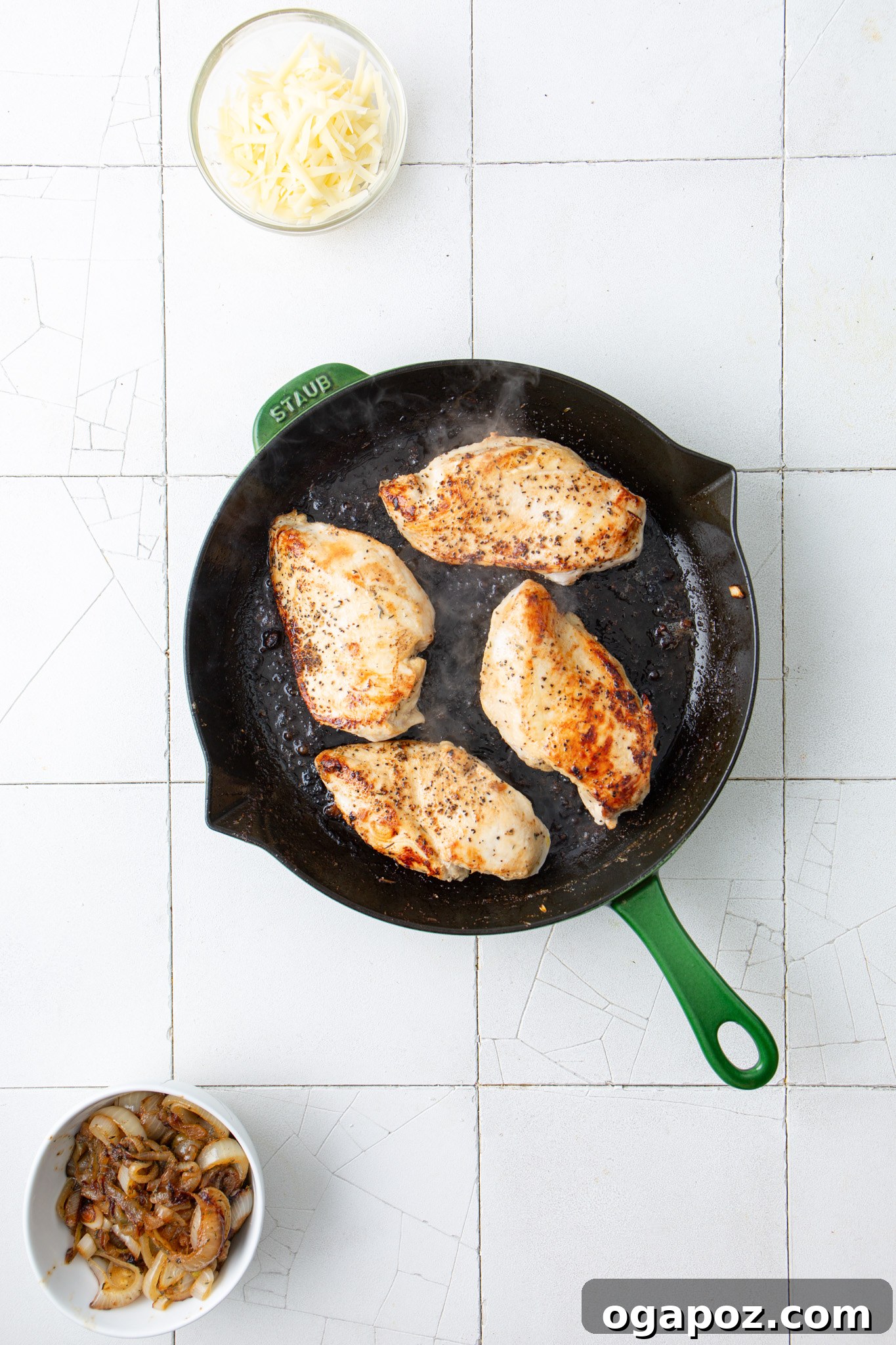 French Onion Smothered Chicken 9 Chicken breasts searing in a skillet.