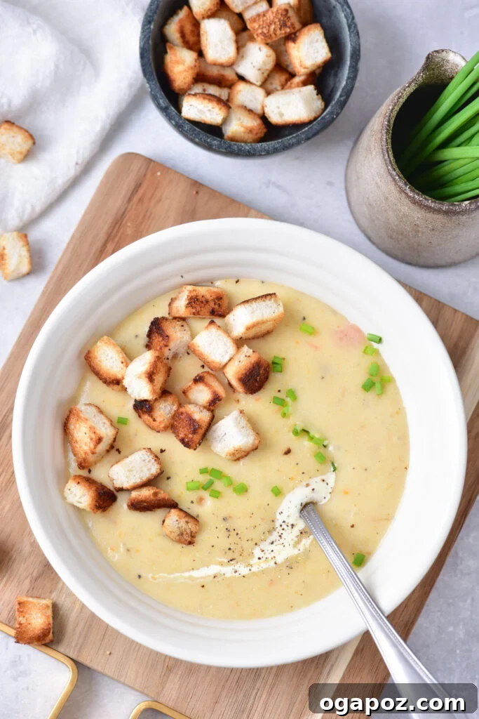 Velvety Potato Leek Soup 3 Overhead shot of Potato Leek Soup on a rustic cutting board, highlighting its wholesome ingredients.